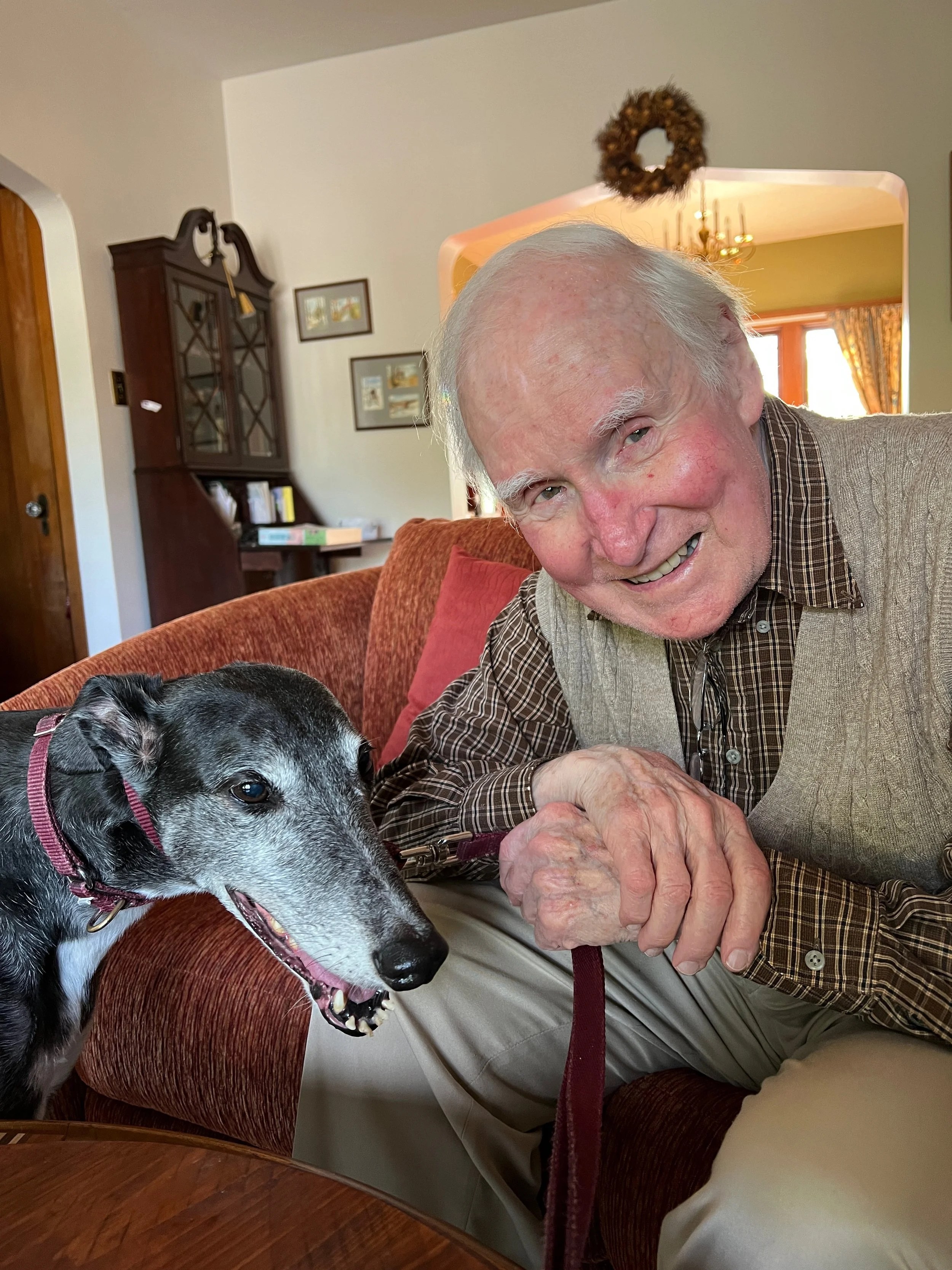 Photo of Stanley Ritchie seated at home with his dog
