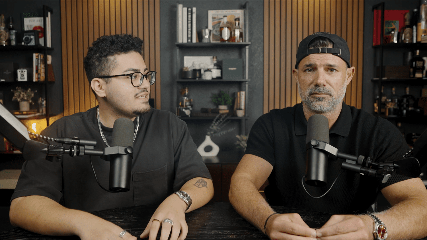Two hosts recording a podcast in the Pensacola studio