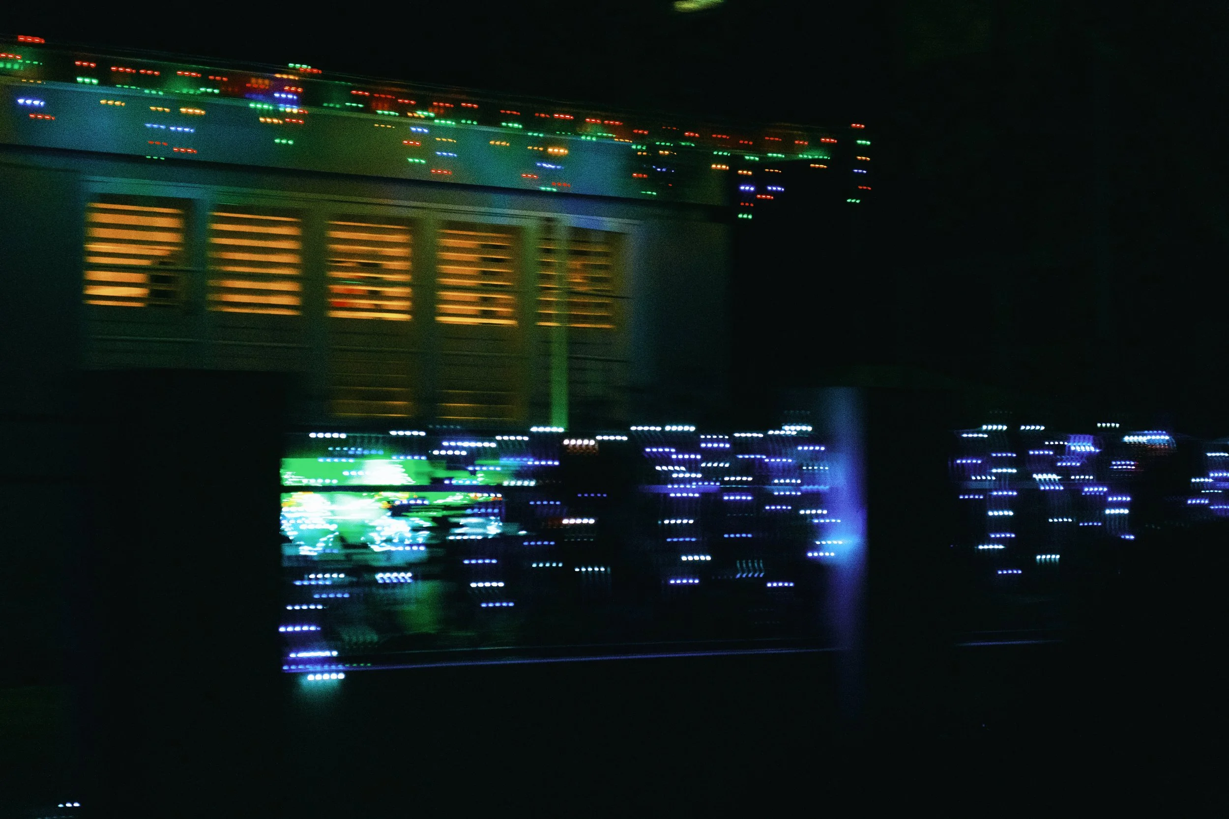 Colorful holiday lights on a house at night.
