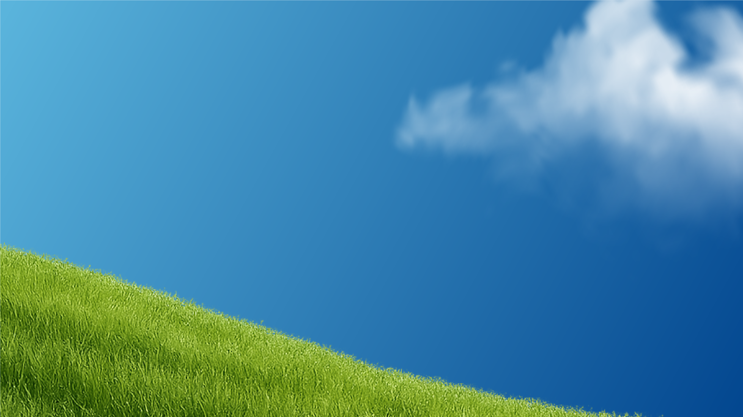 A grassy hill under a clear blue sky with a few white clouds.