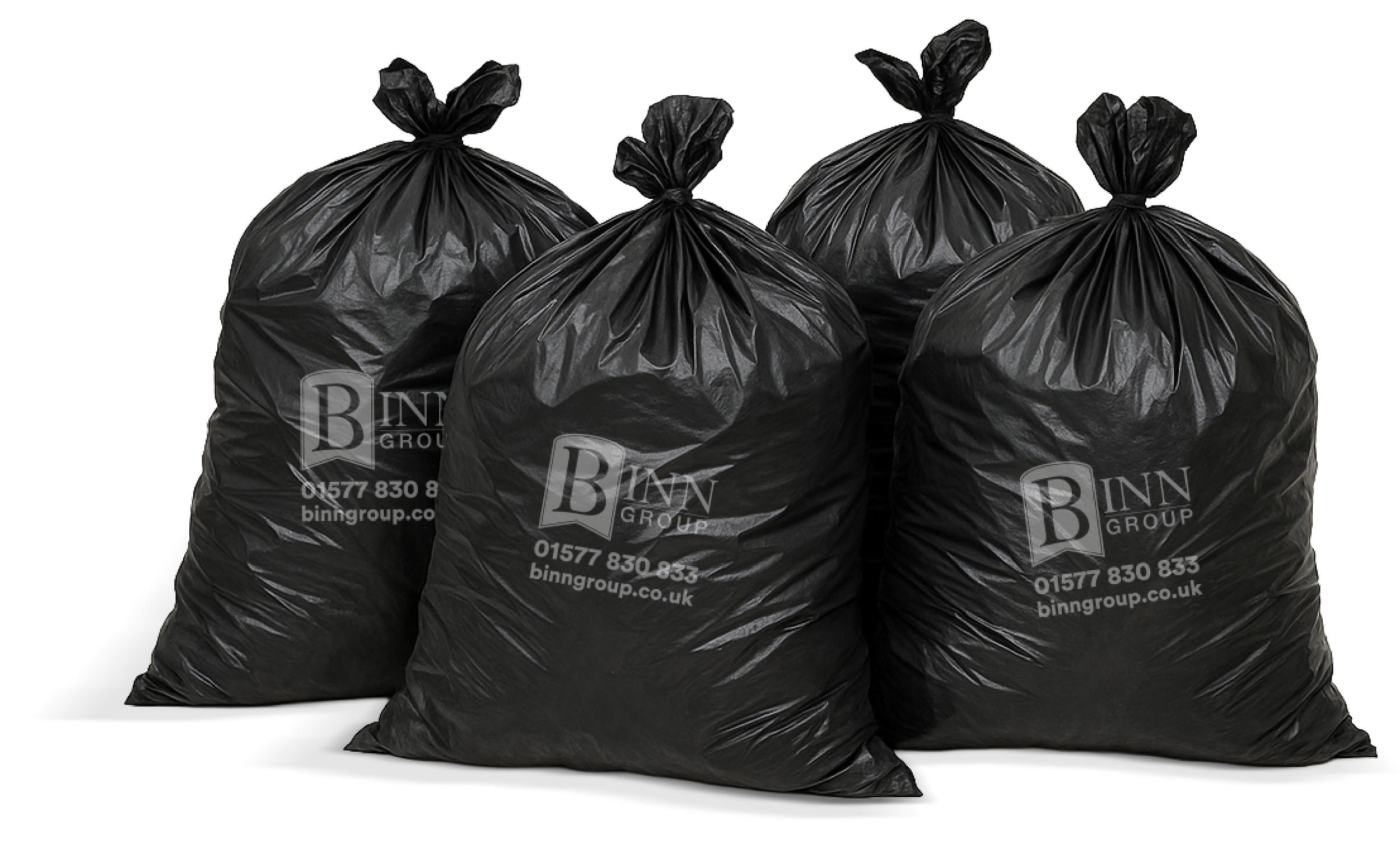 Four black garbage bags with printed company information on a dark background.