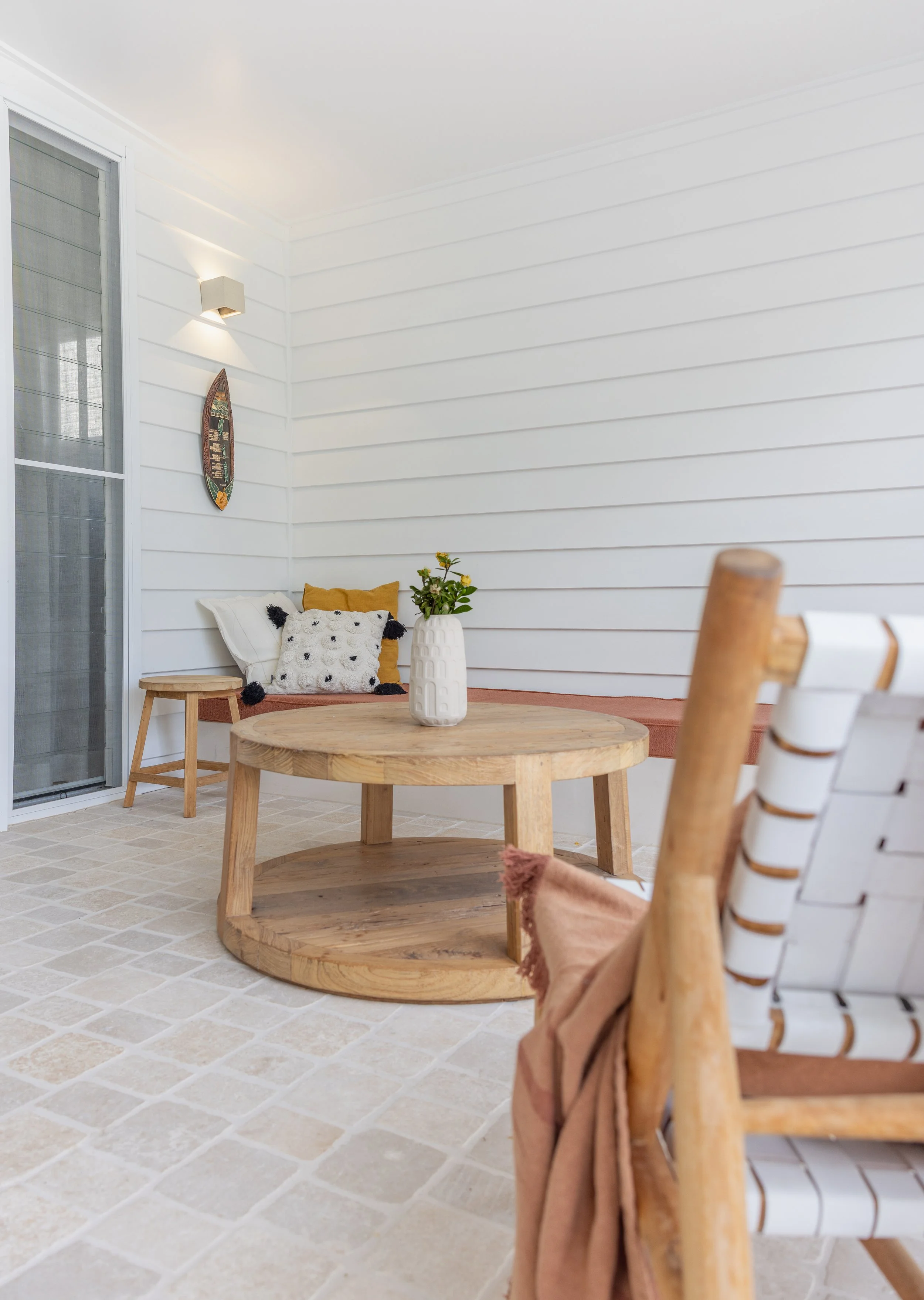 Relaxing back porch area with earthy tones and inviting atmosphere.