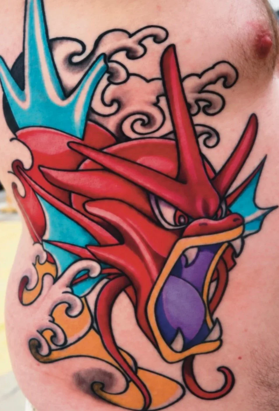 Traditional color dragon tattoo by Chris Layman, serving Gulf Shores, Foley, Orange Beach, and Pensacola. Bold color, strong outlines, and classic traditional tattoo influence.