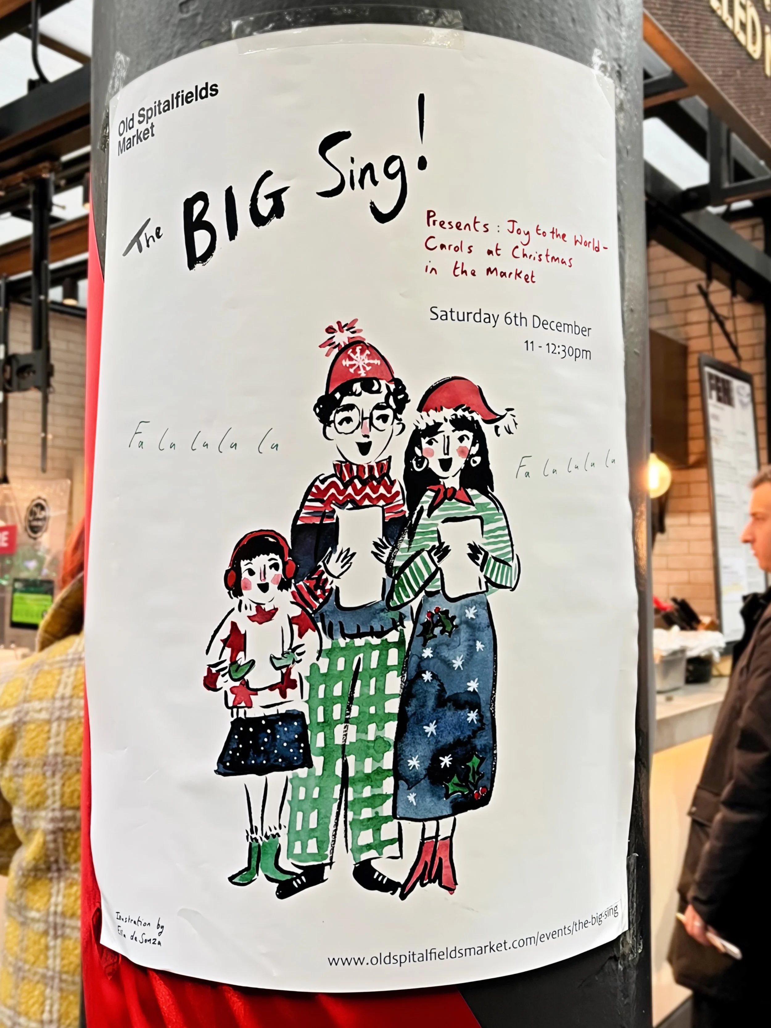 A poster on a pole showing a family of three singing in a cute hand drawn ink style