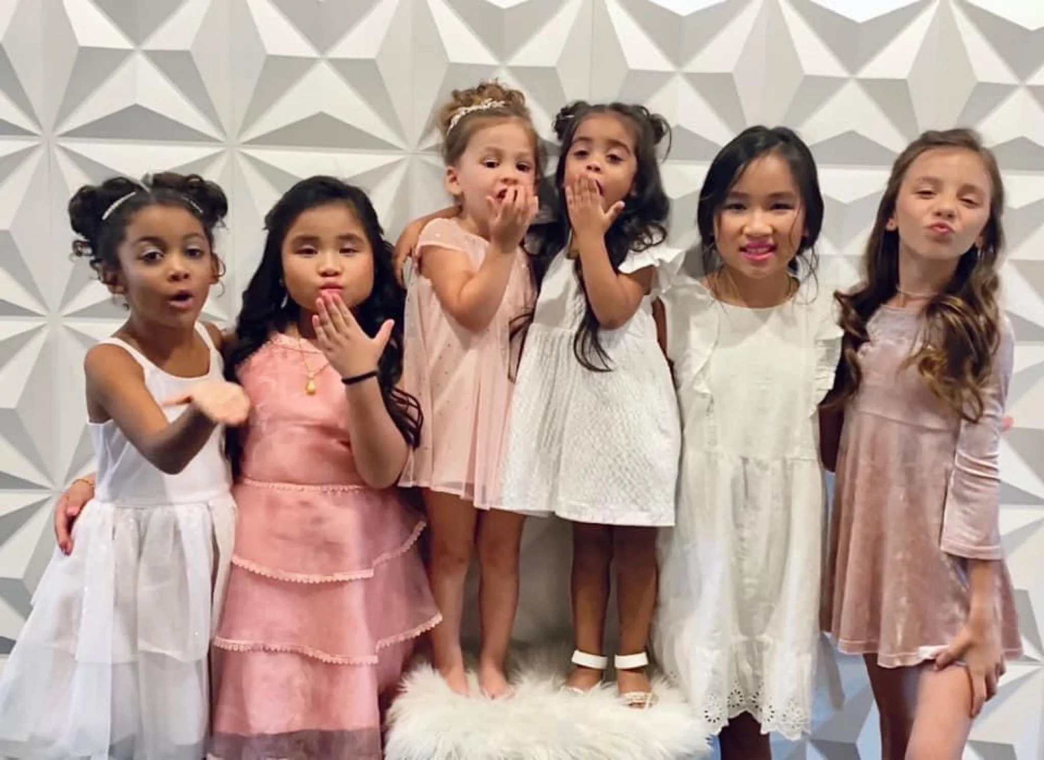 toddler girls blowing kisses