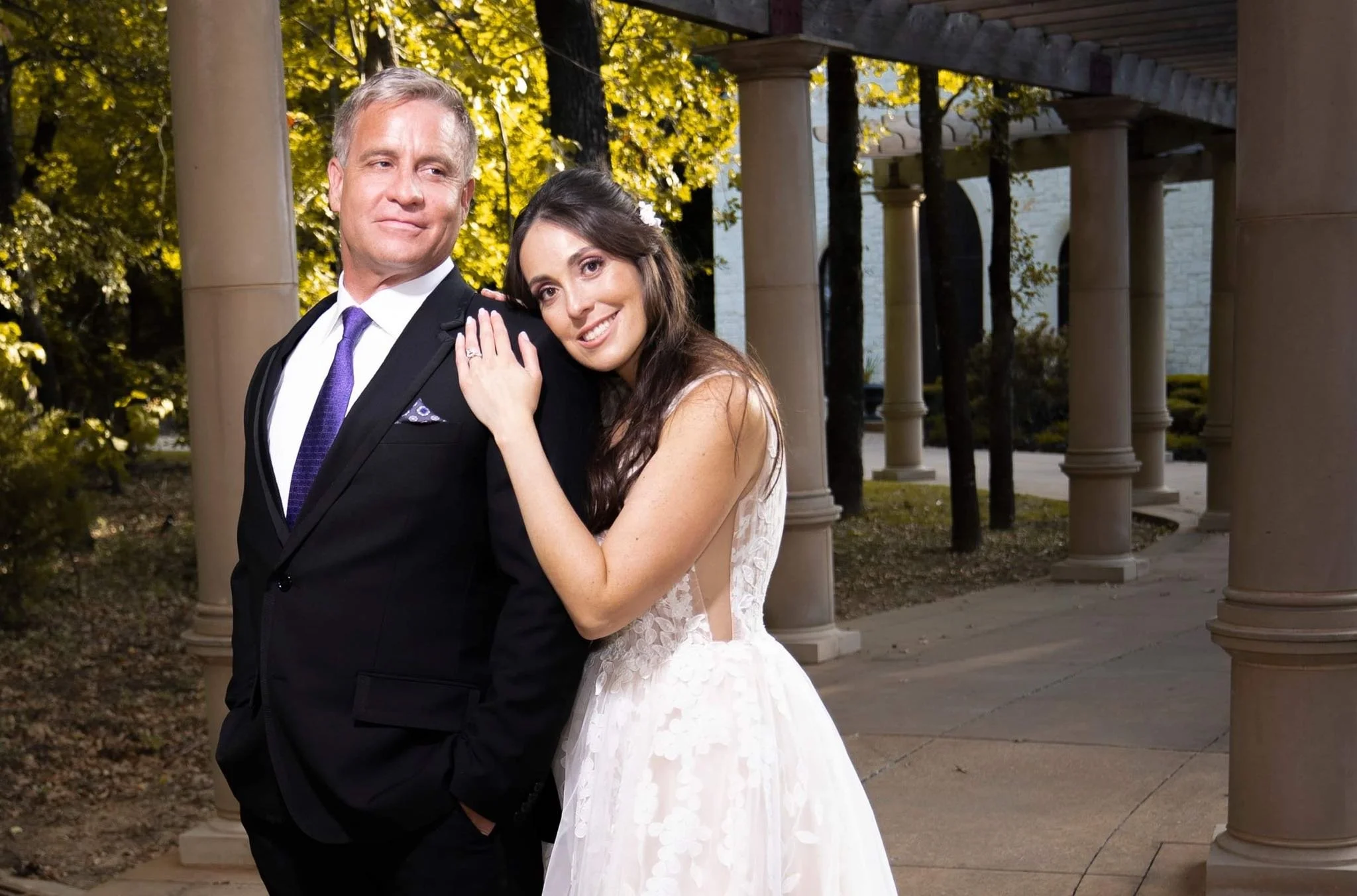 bride leaning on grooms shoulder