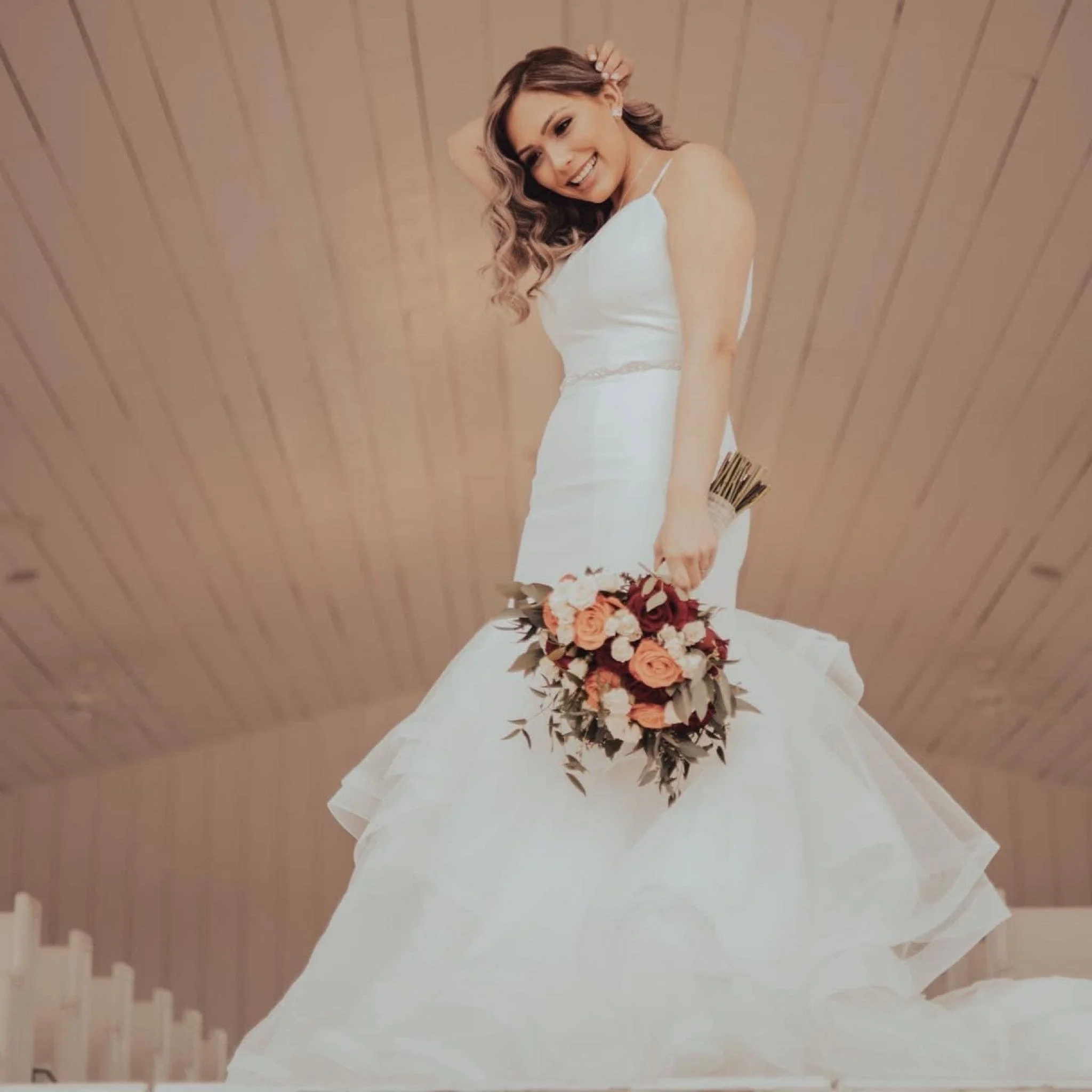bride with mermaid dress and flower bouquet