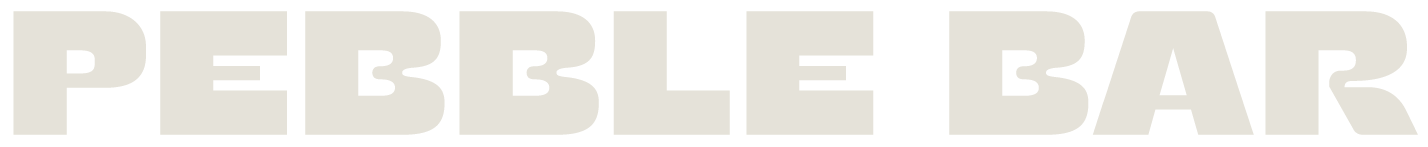 Close-up of a sign that reads 'PEBBLE BAR' in bold, uppercase letters.