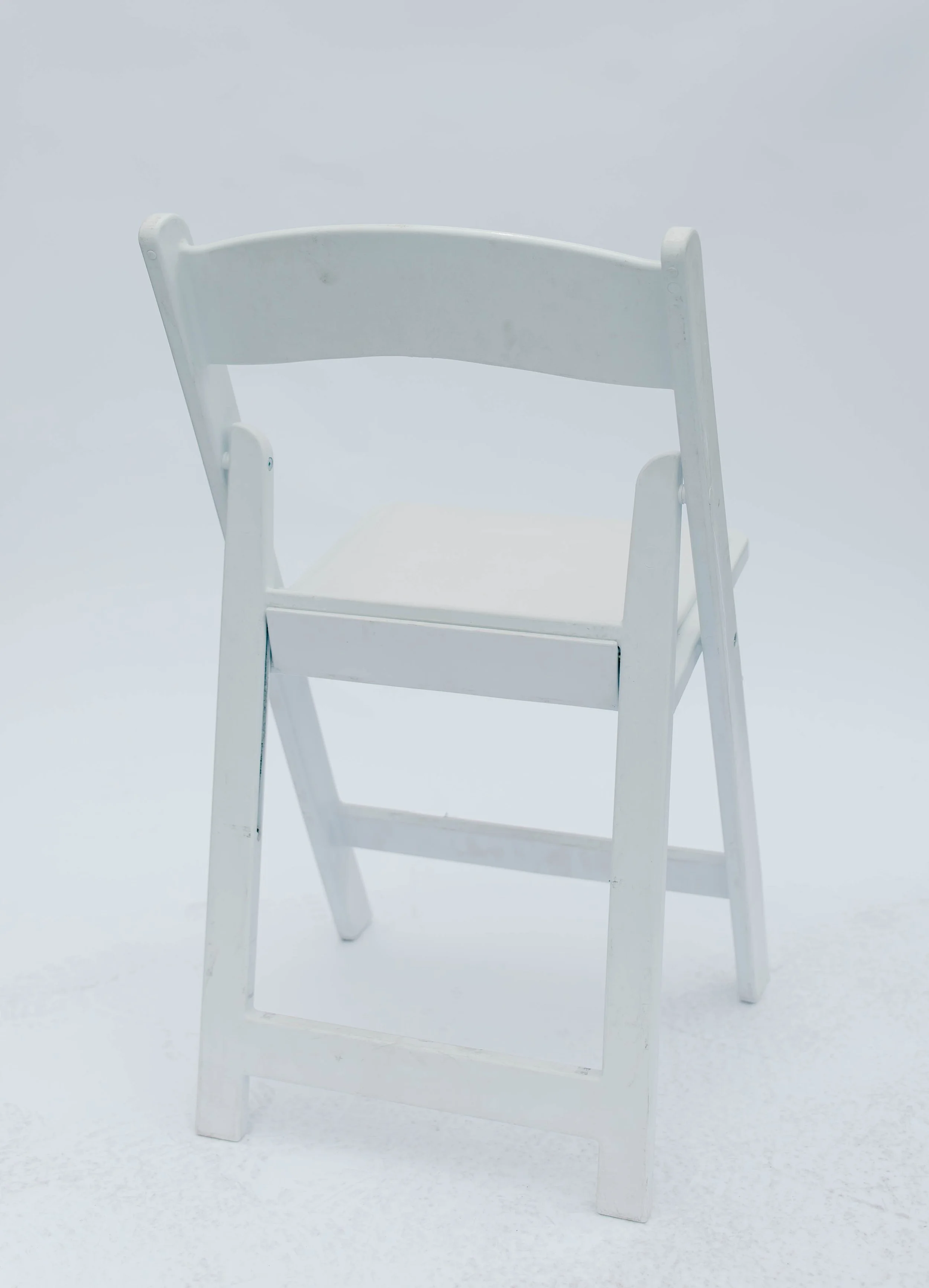 White folding chair on a white background.