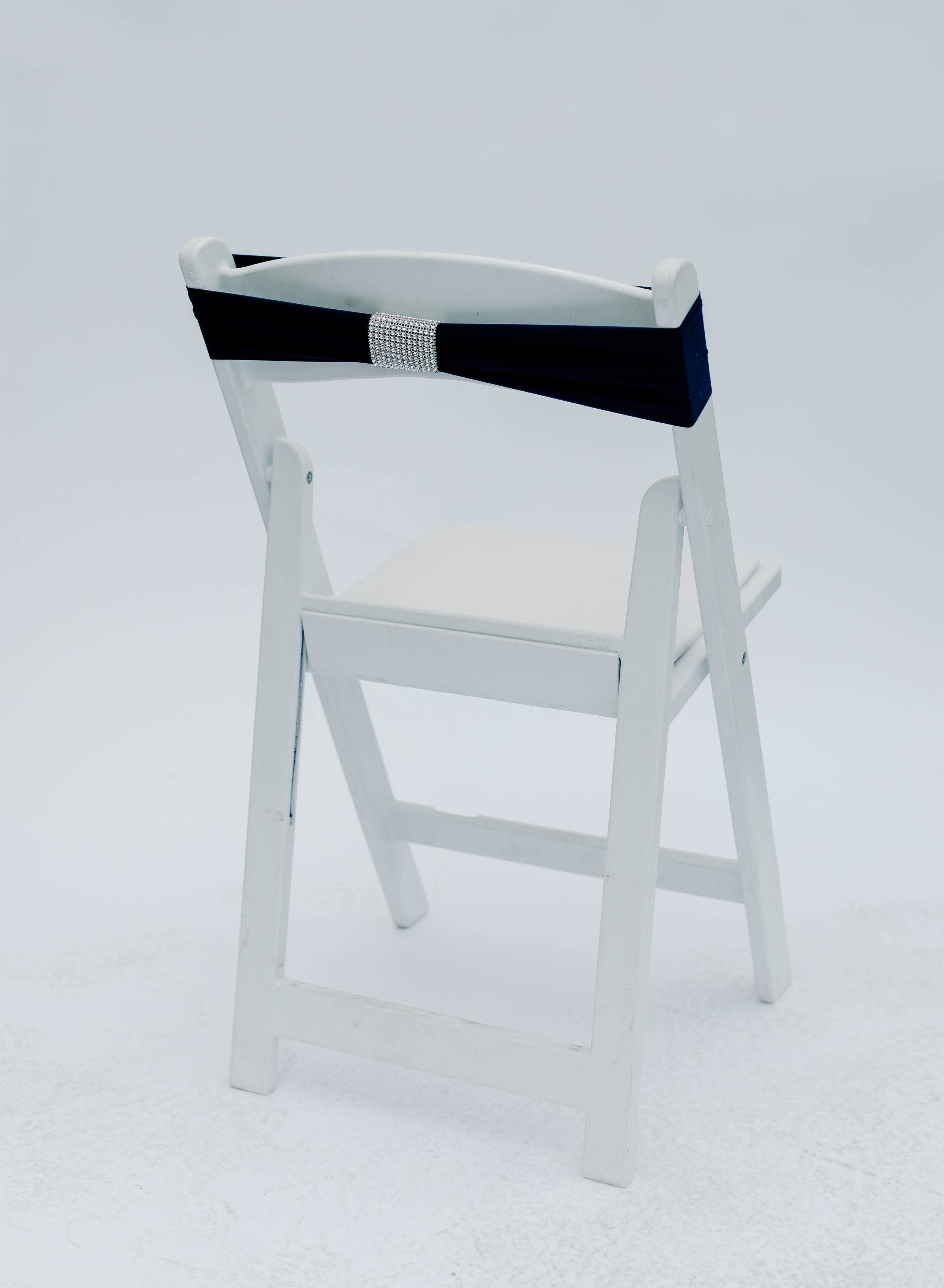 White wooden chair with a black and silver band around the top rail, set against a plain white background.