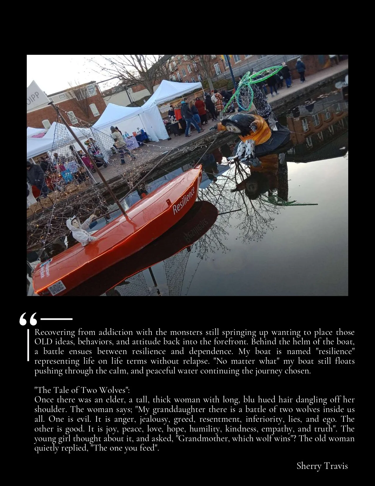 Decorative boat with a figure and the word 'Resilience' on the side floating in calm water, with a reflection visible. The boat has spider web-like decorations and a small figure seated at the stern. Behind, there are white tents and people walking at an outdoor event on a city street lined with buildings, and bare trees are visible.