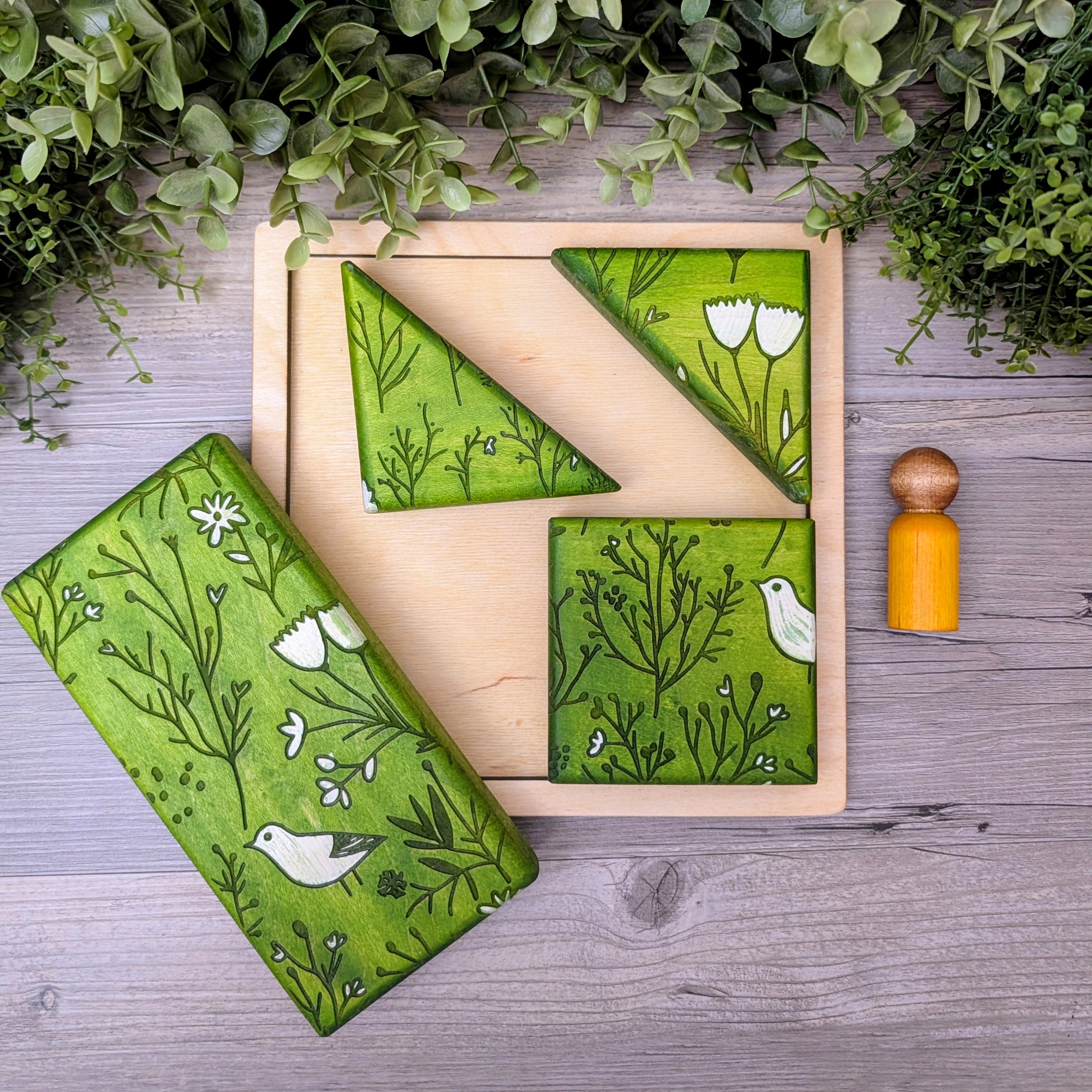 Bird and flower patterned wooden blocks in green and white