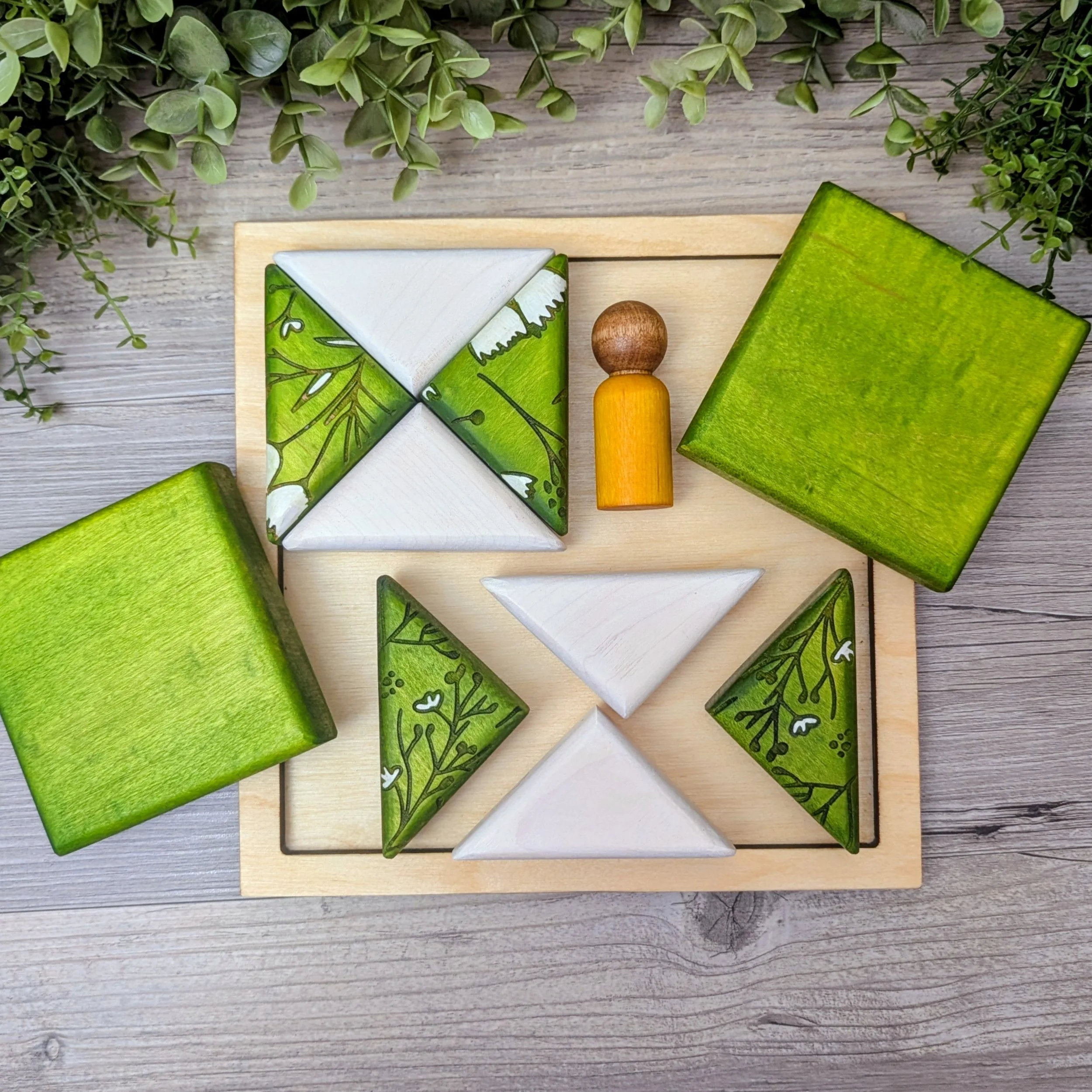 Bird and flower patterned wooden blocks in green and white