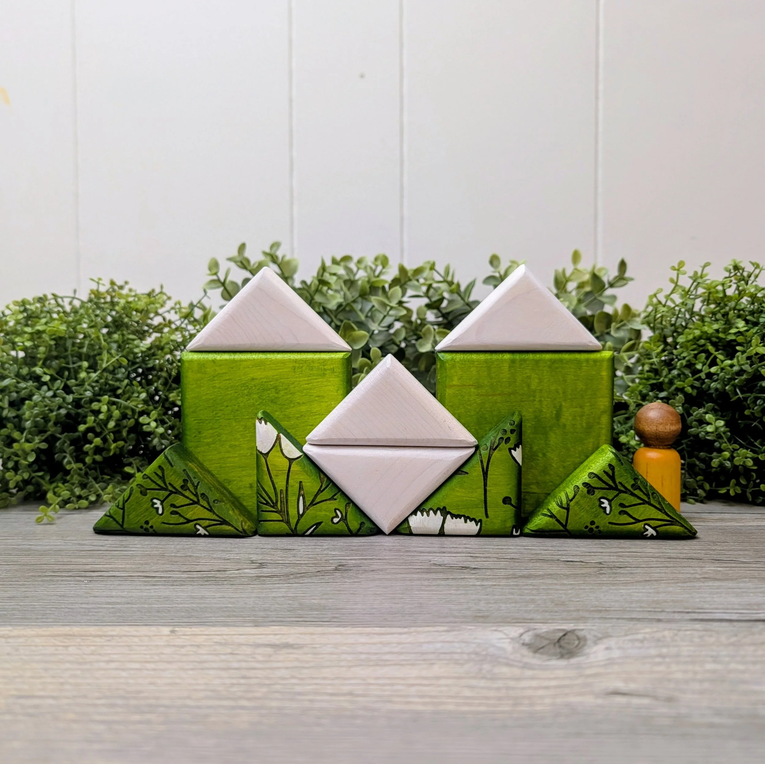 Green and white patterned wooden puzzle featuring bird and floral designs