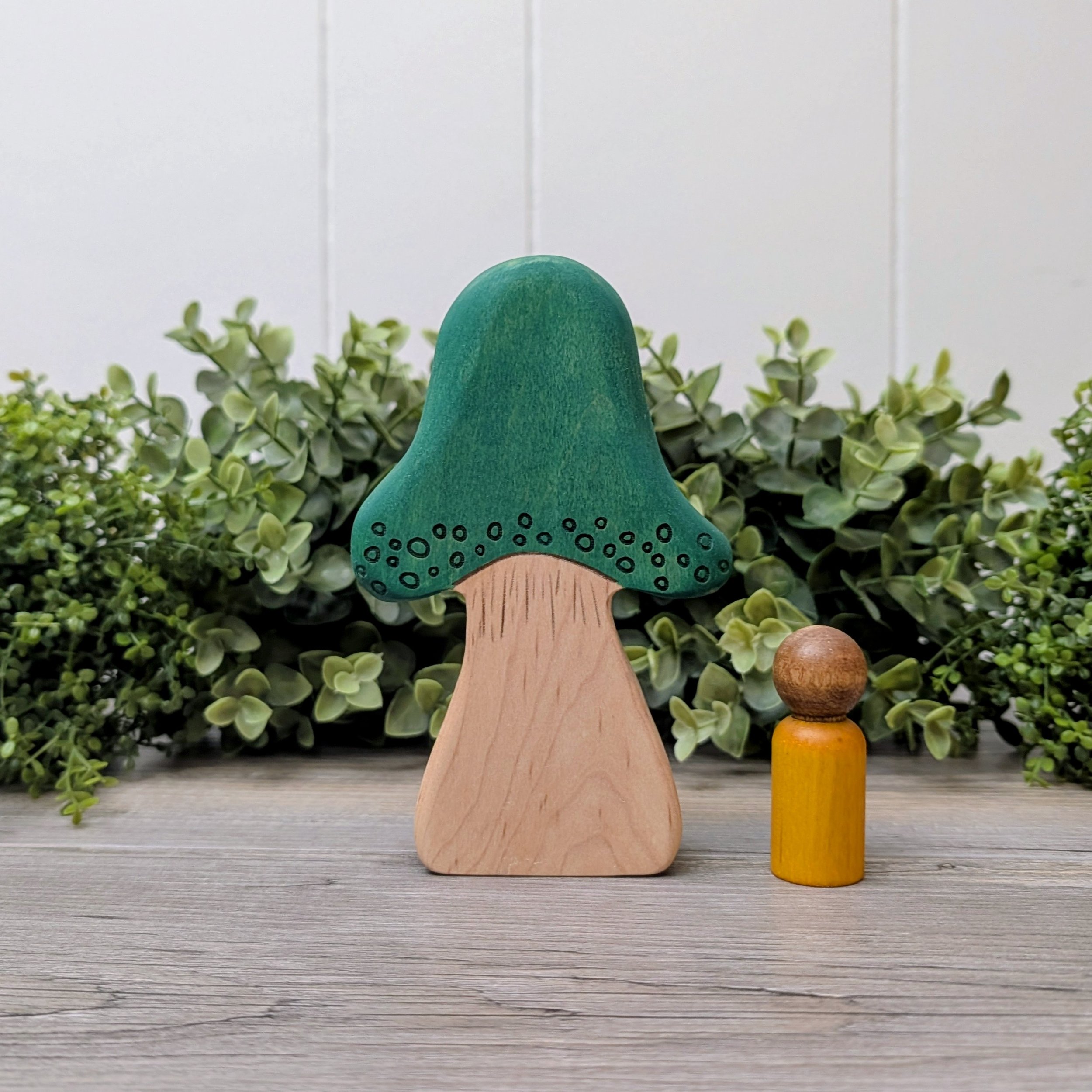 Teal wooden mushroom tree with hand drawn laser detailing
