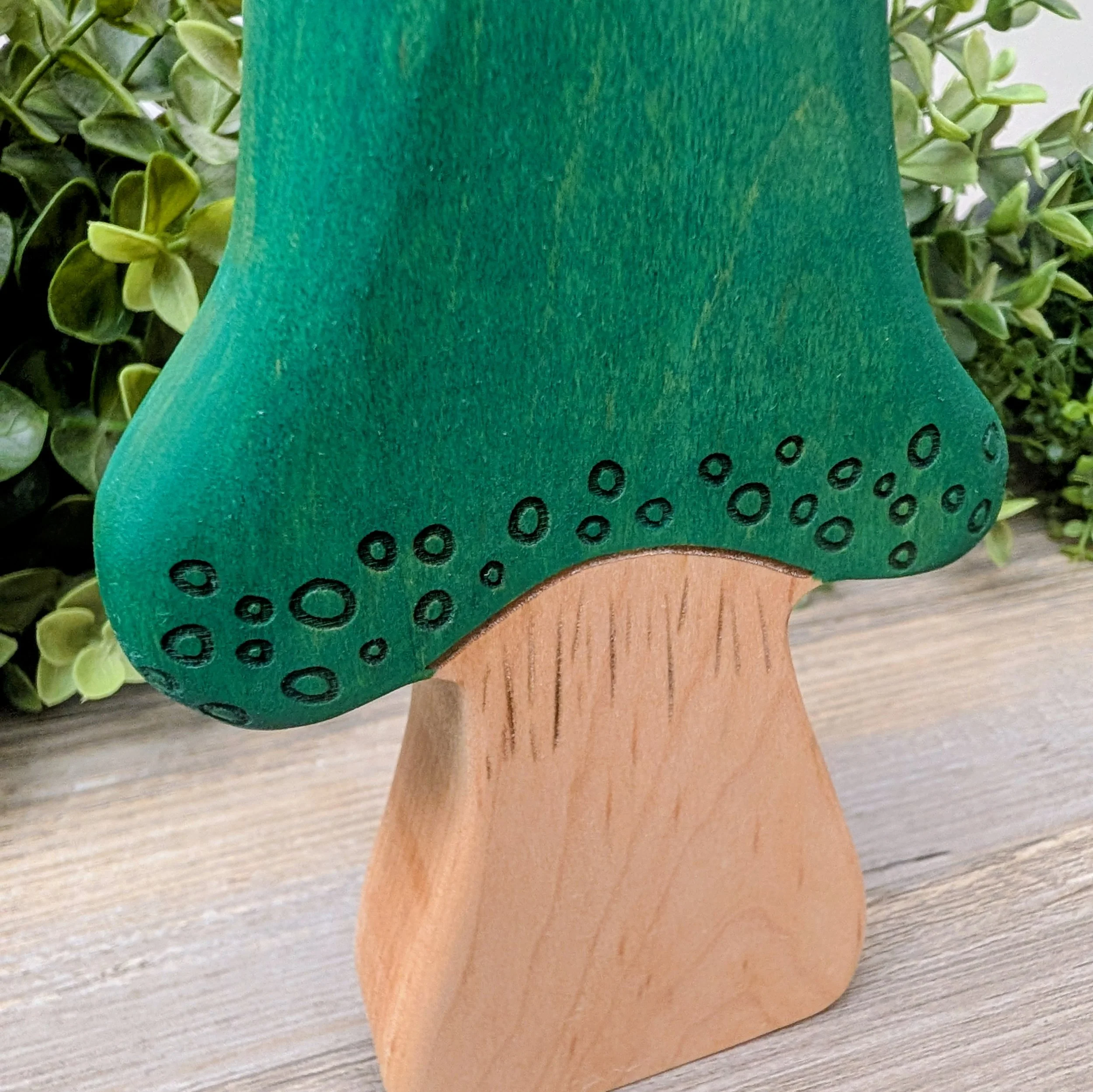 Close up of laser detailed wooden mushroom finished with toy compliant stain