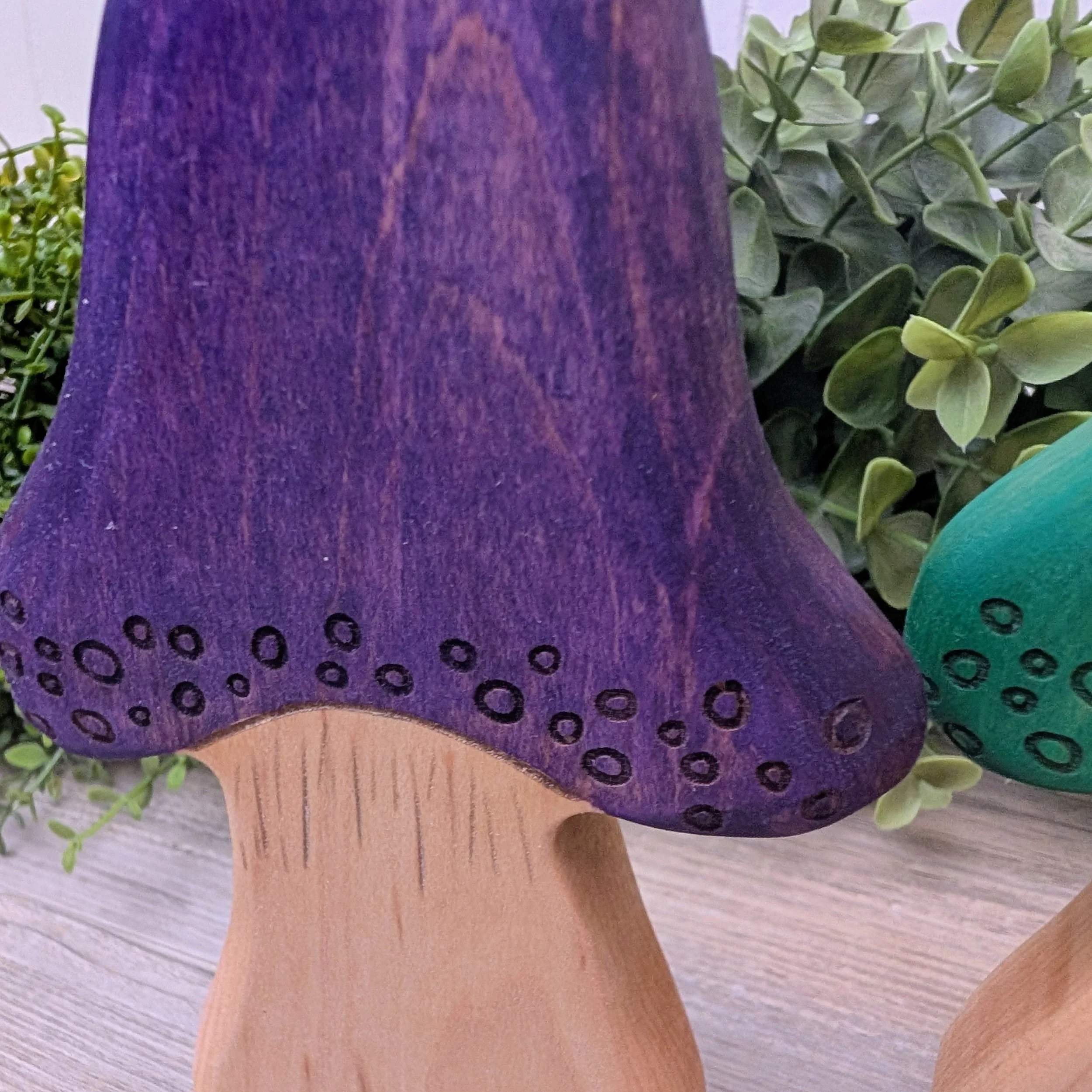 Close up of laser detailed wooden mushroom finished with toy compliant stain