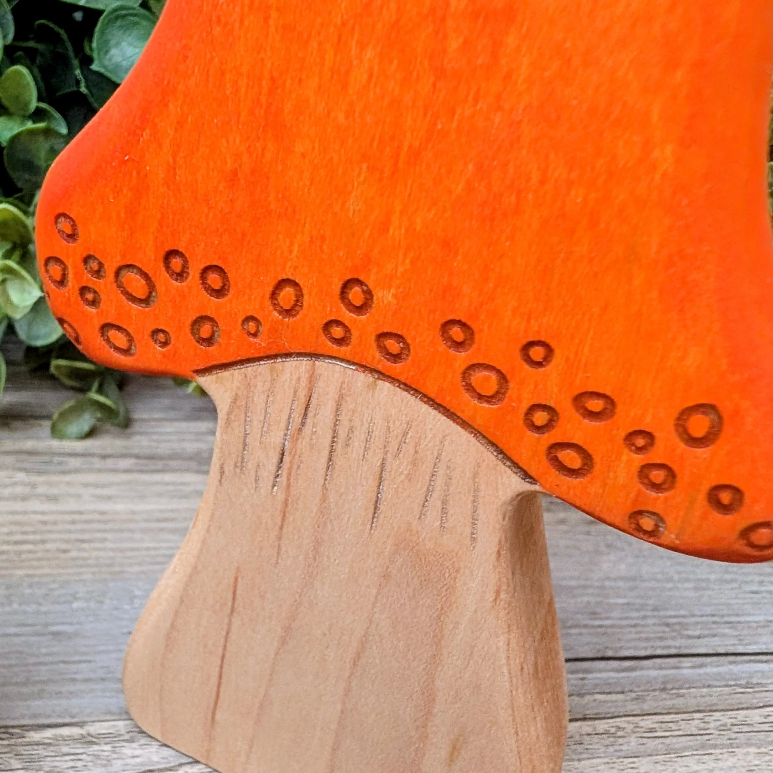 Close up of laser detailed wooden mushroom finished with toy compliant stain