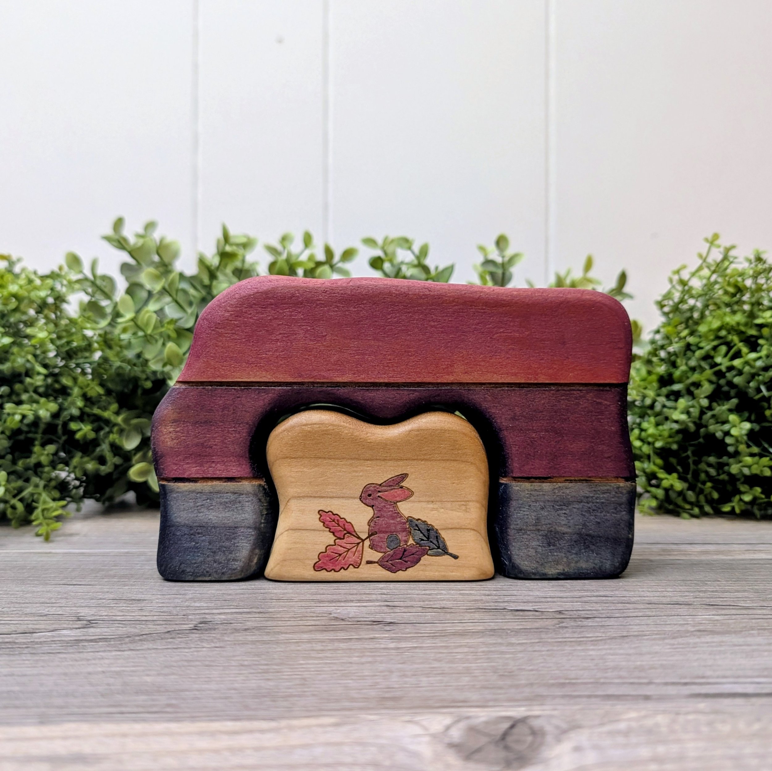 Hand painted wooden bunny cave stacker in pink, purple, and blue bi pride colors