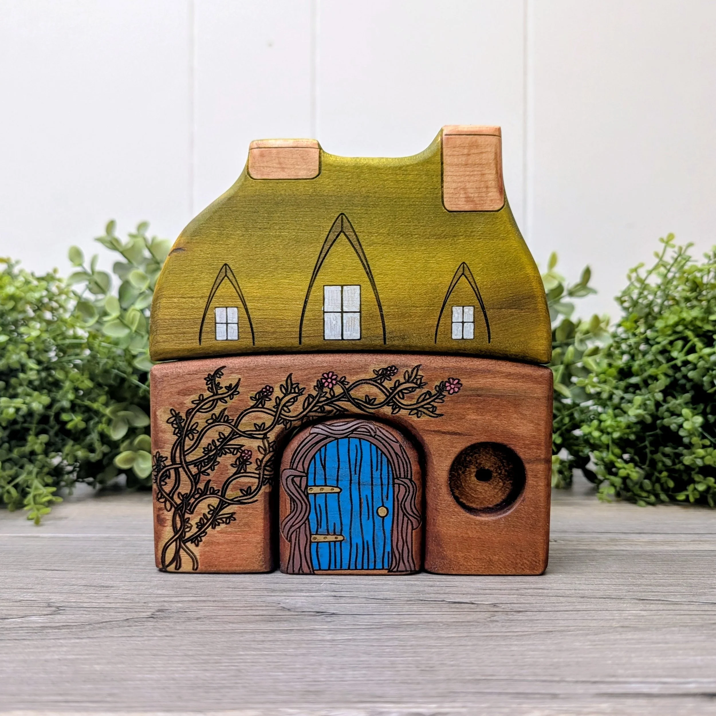 Handmade wooden Tom Bombadil inspired house with blue door and mossy green roof