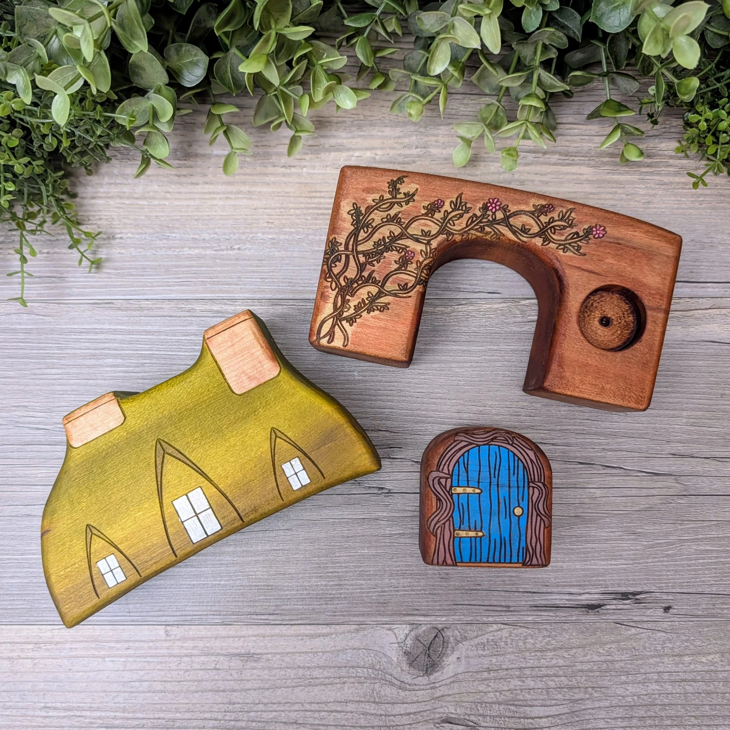 Wooden storybook house featuring vines and partially drilled window