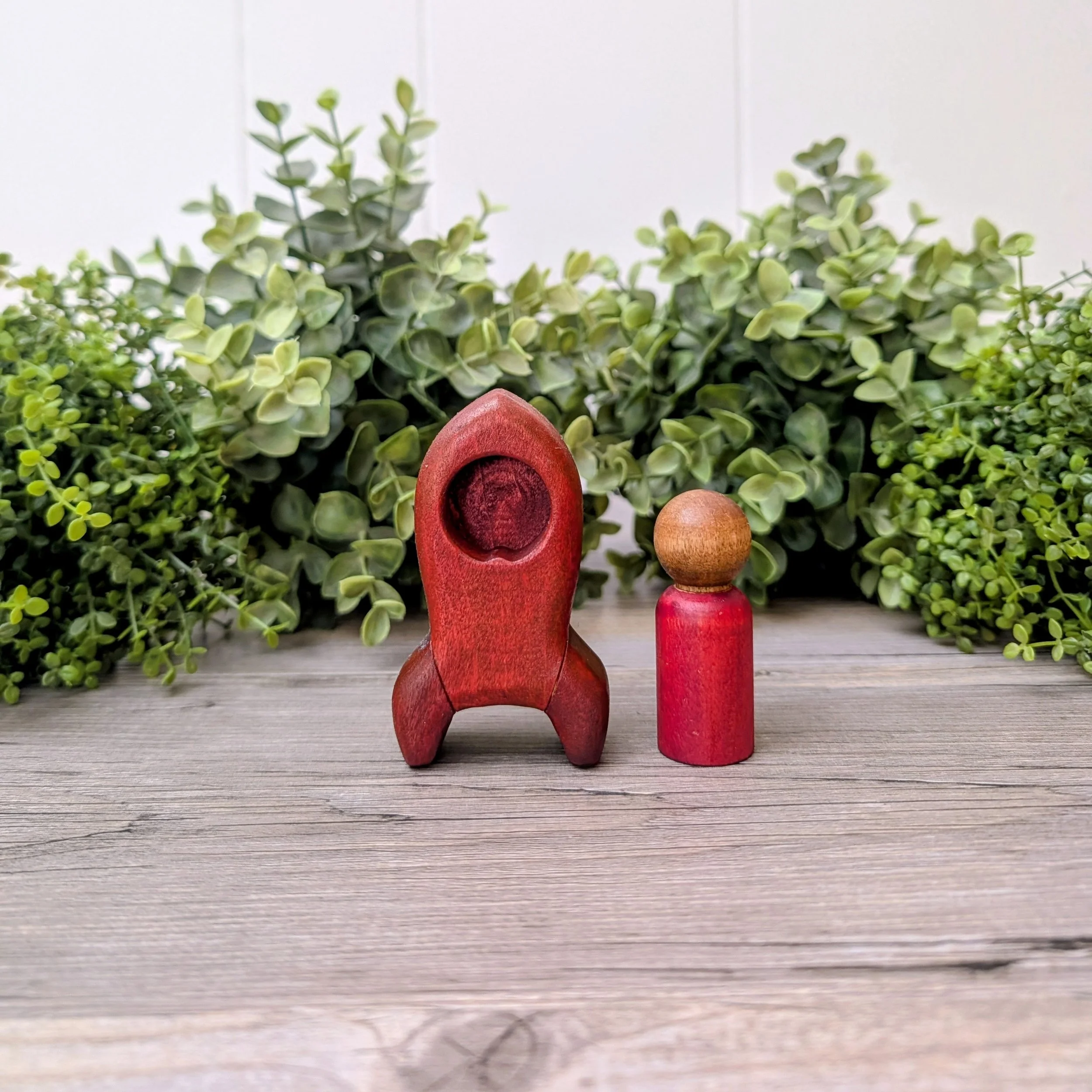 Wooden rocket ship toy with matching maple peg person