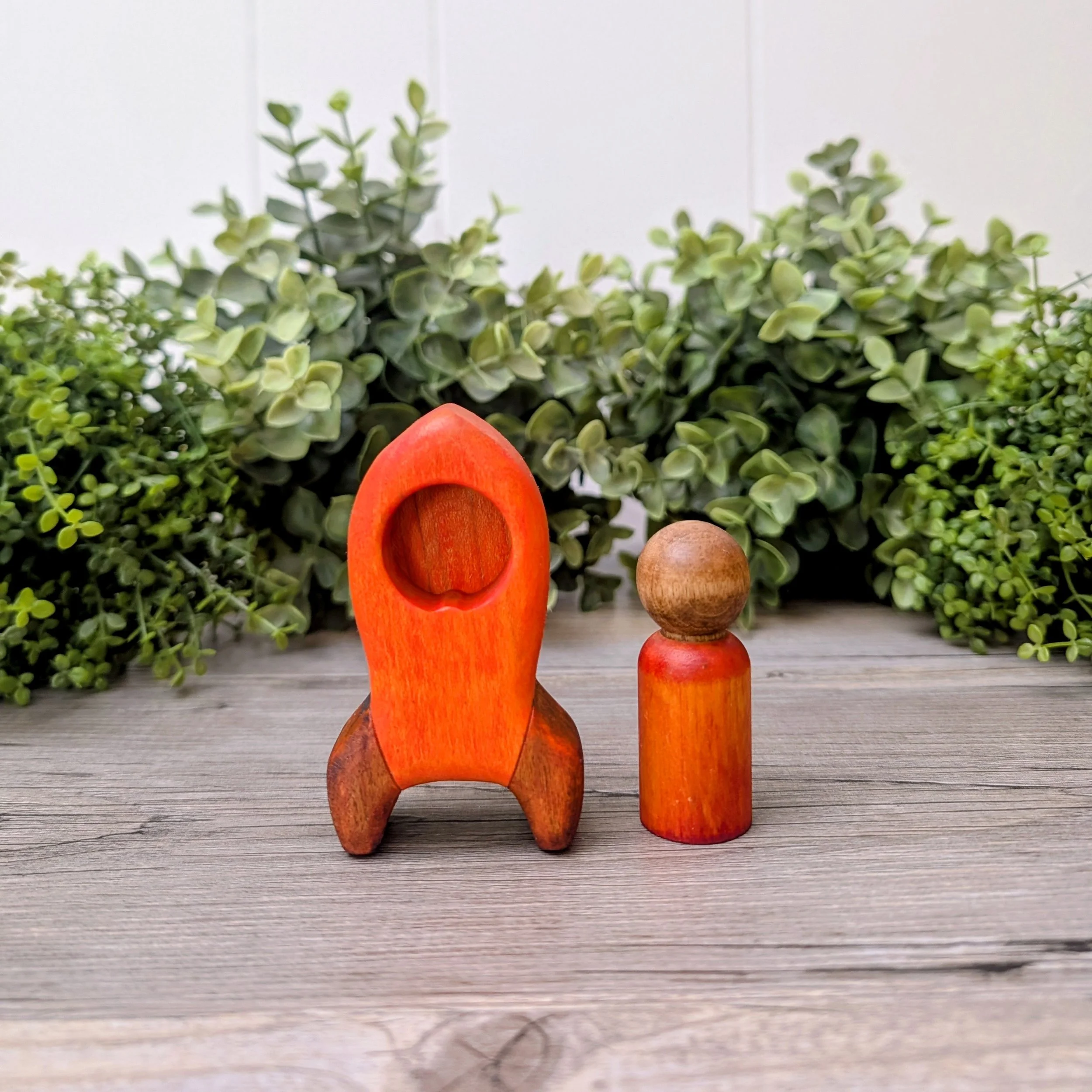 Wooden rocket ship toy with matching maple peg person