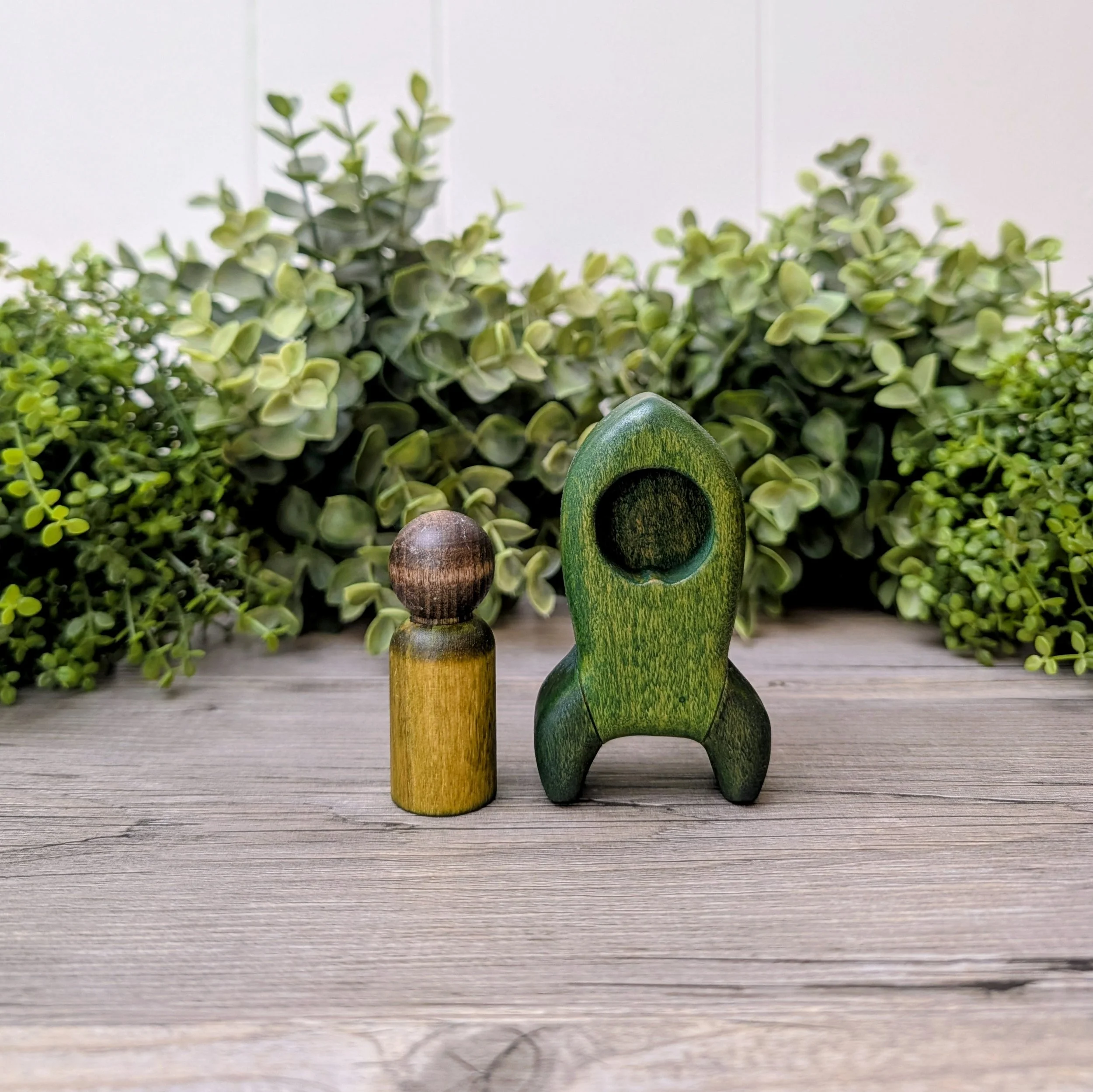 Wooden rocket ship toy with matching maple peg person
