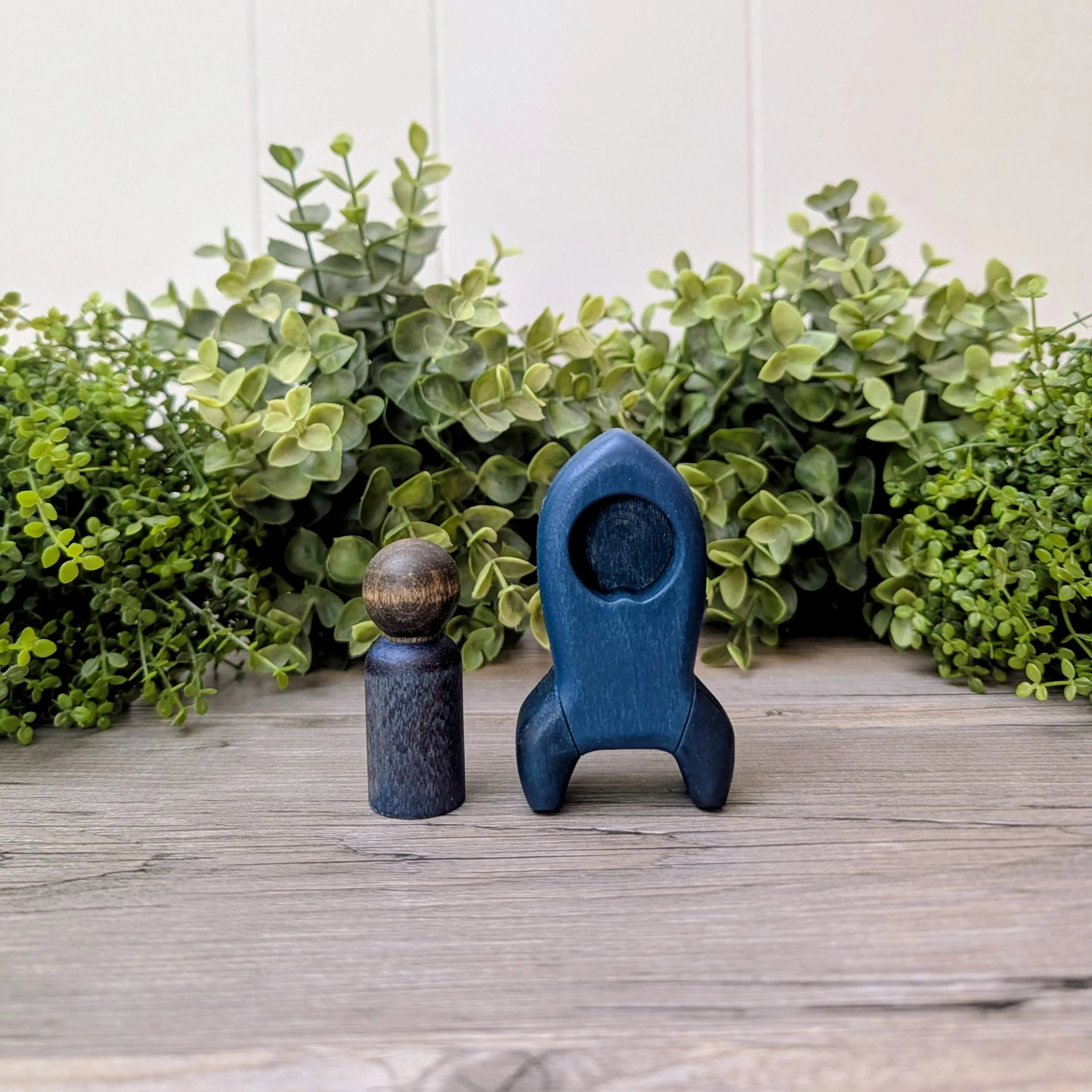 Wooden rocket ship toy with matching maple peg person