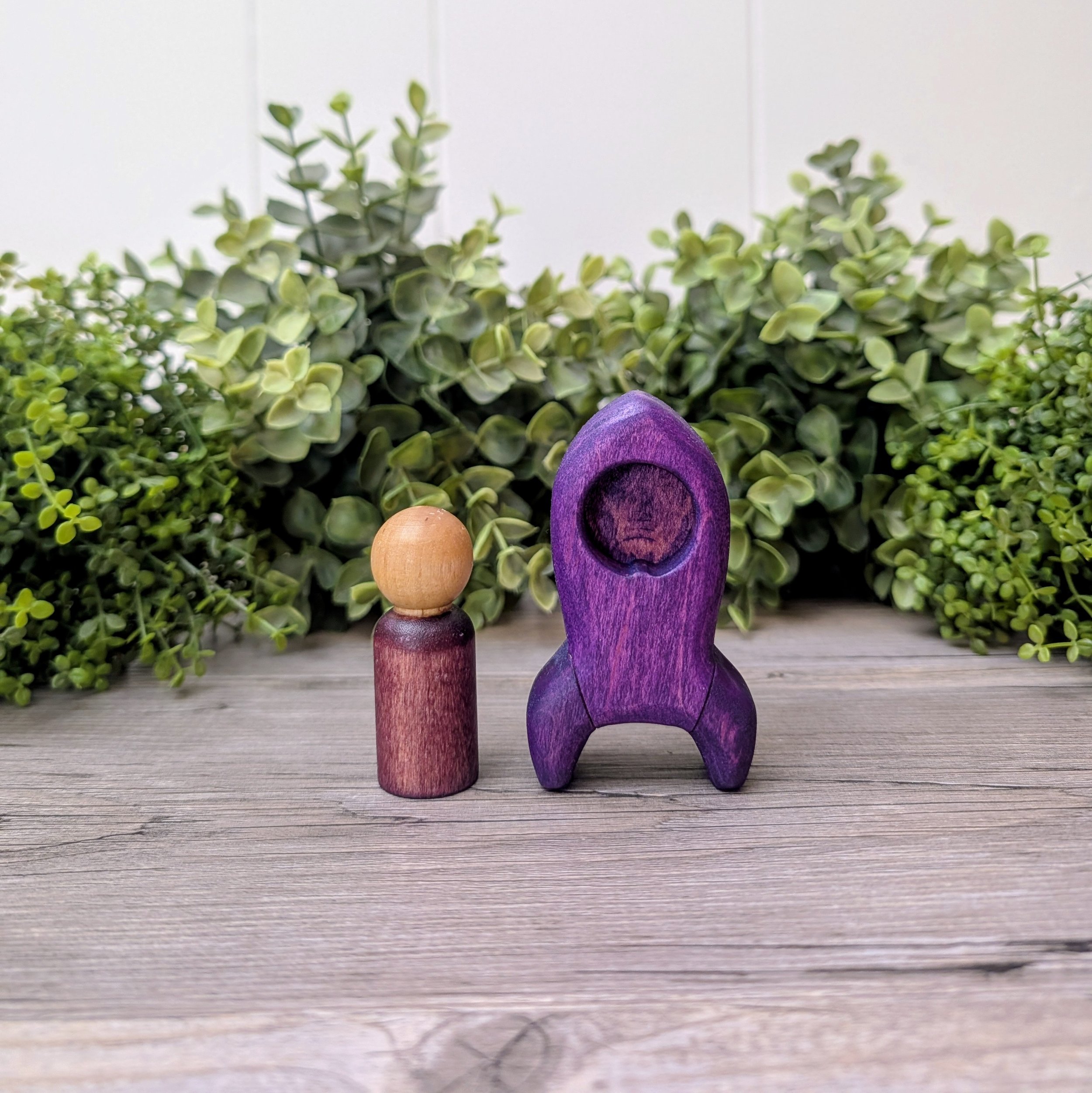 Wooden rocket ship toy with matching maple peg person