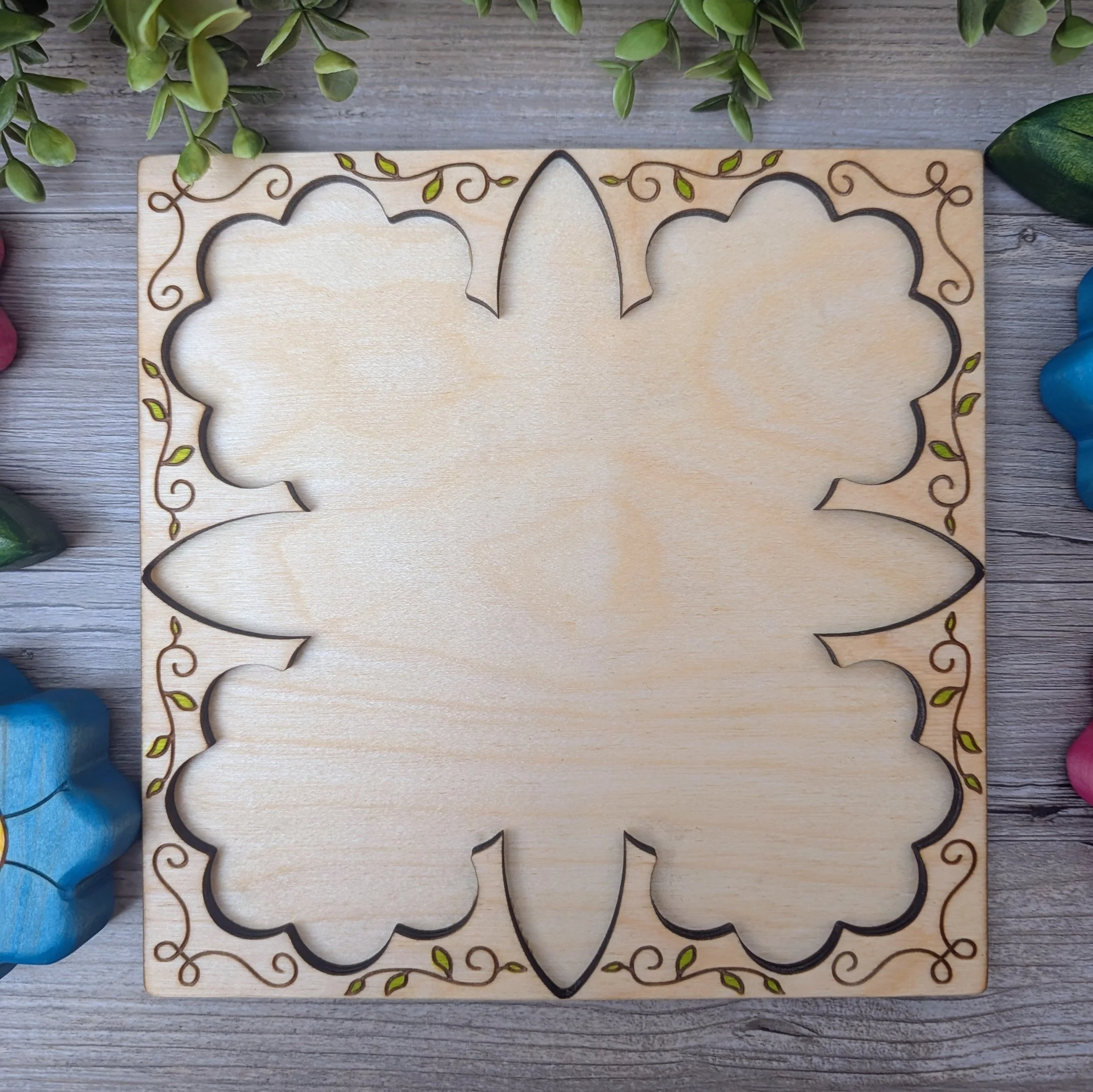 Wooden puzzle frame with hand drawn vine detail and painted leaves