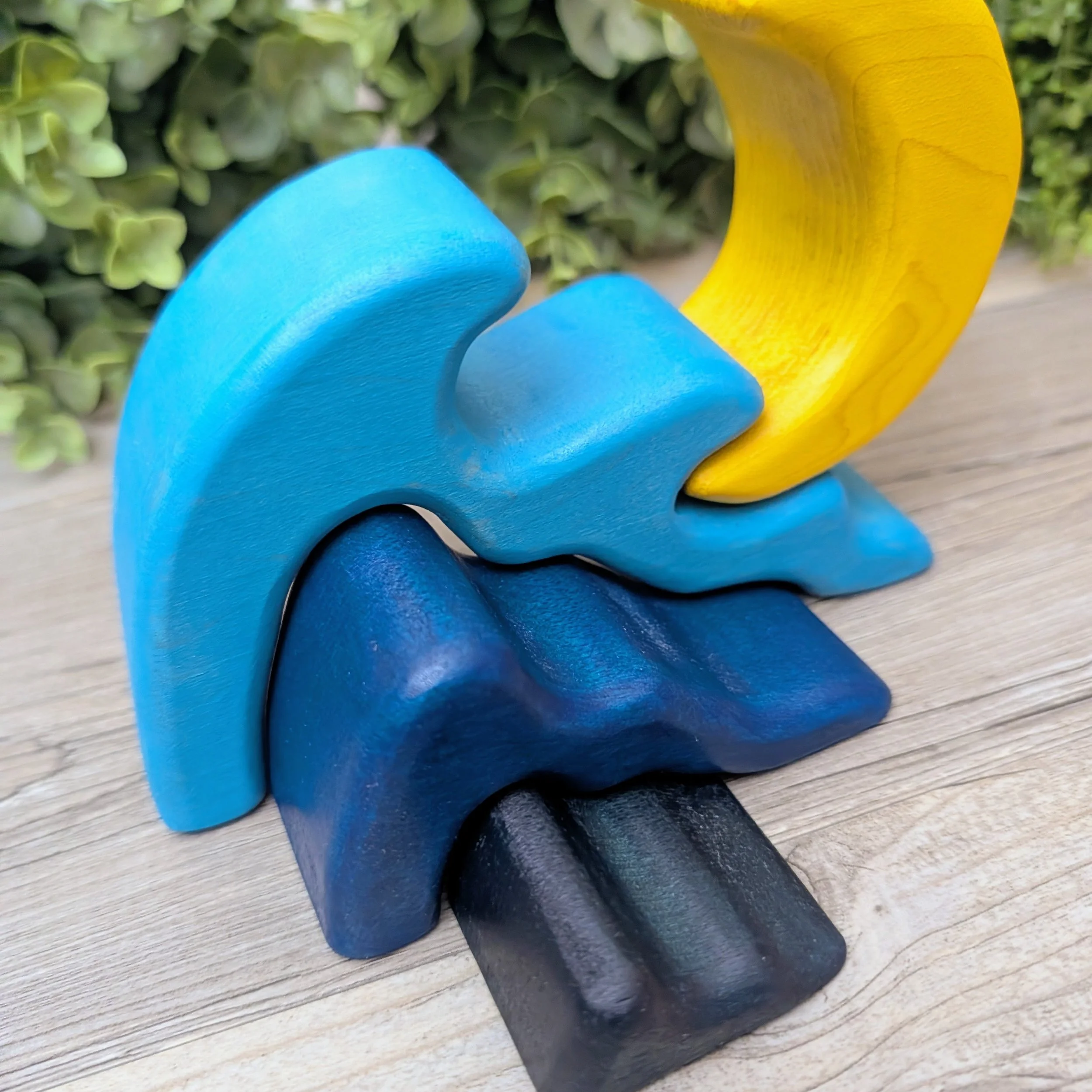 Three piece wooden wave stacking toy in light to dark blue