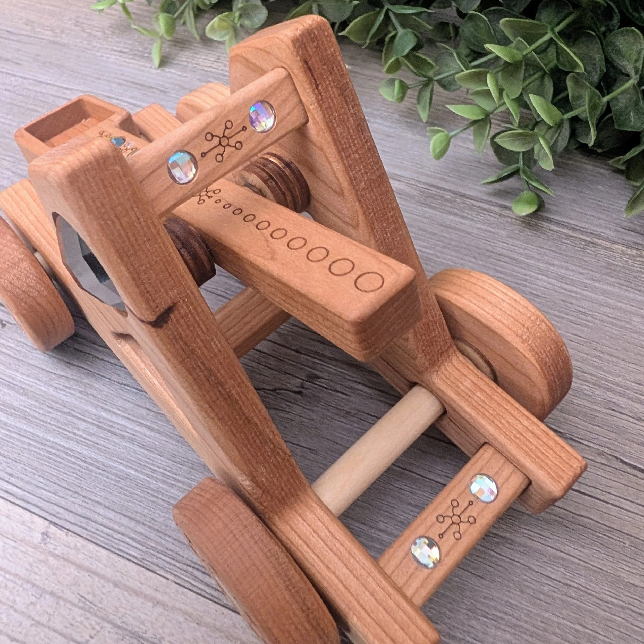 Wooden fantasy catapult for small world play with rainbow gem accents