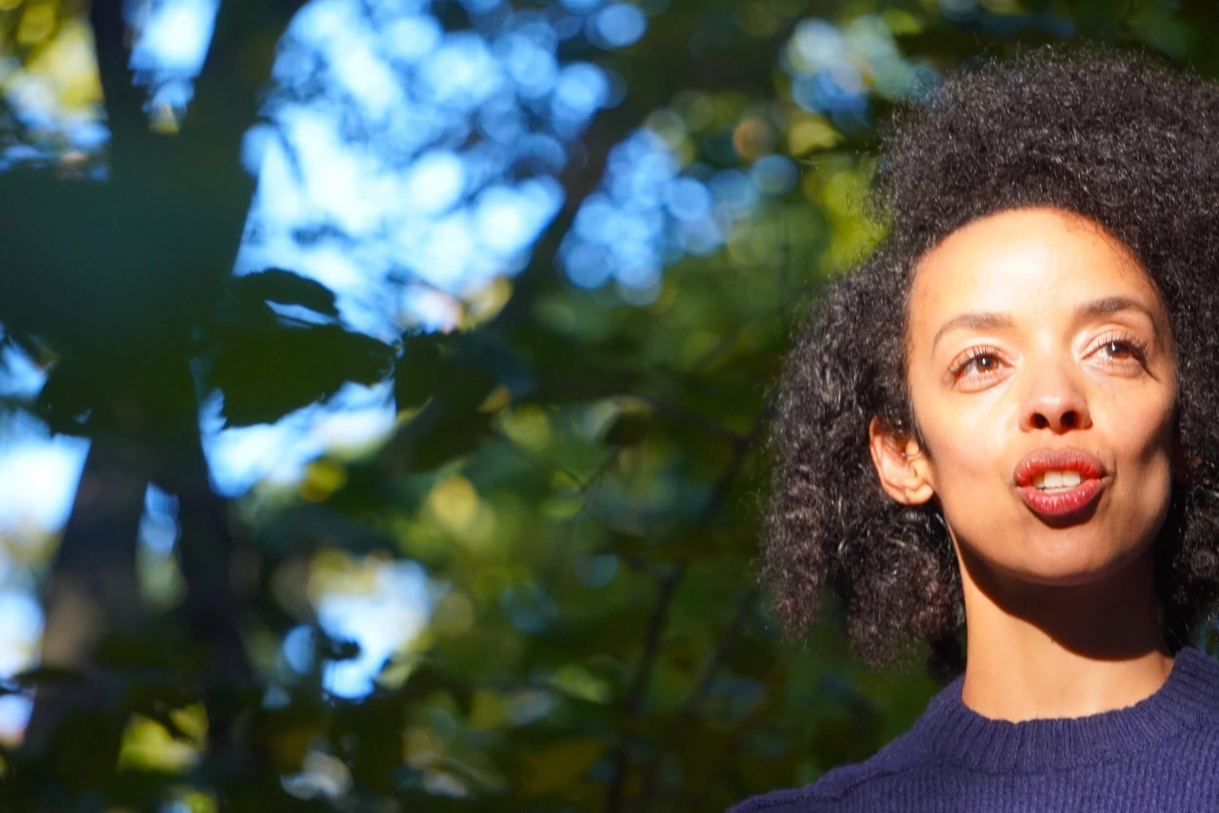 image of Kissey Asplund speaking with forest behind her