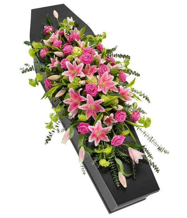 A beautiful trailing casket spray of vibrant pink roses and Stargazer lilies. Eucalyptus and blousy viburnum elevate the arrangement and give it a contemporary feel.