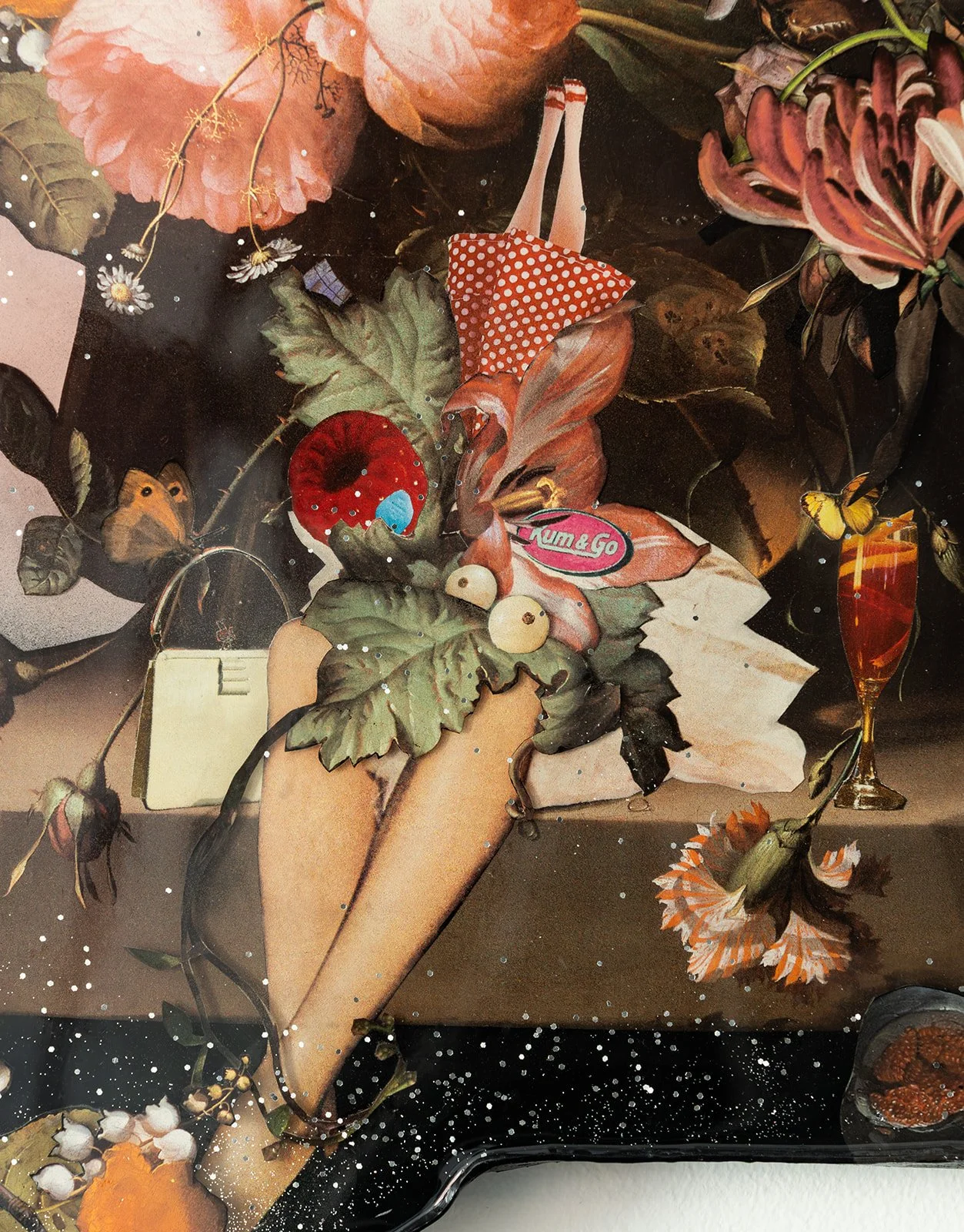 A floral arrangement with various flowers, leaves, a red mushroom, a lipstick, a note, a butterfly, and a glass of orange drink on a dark background with white speckles.