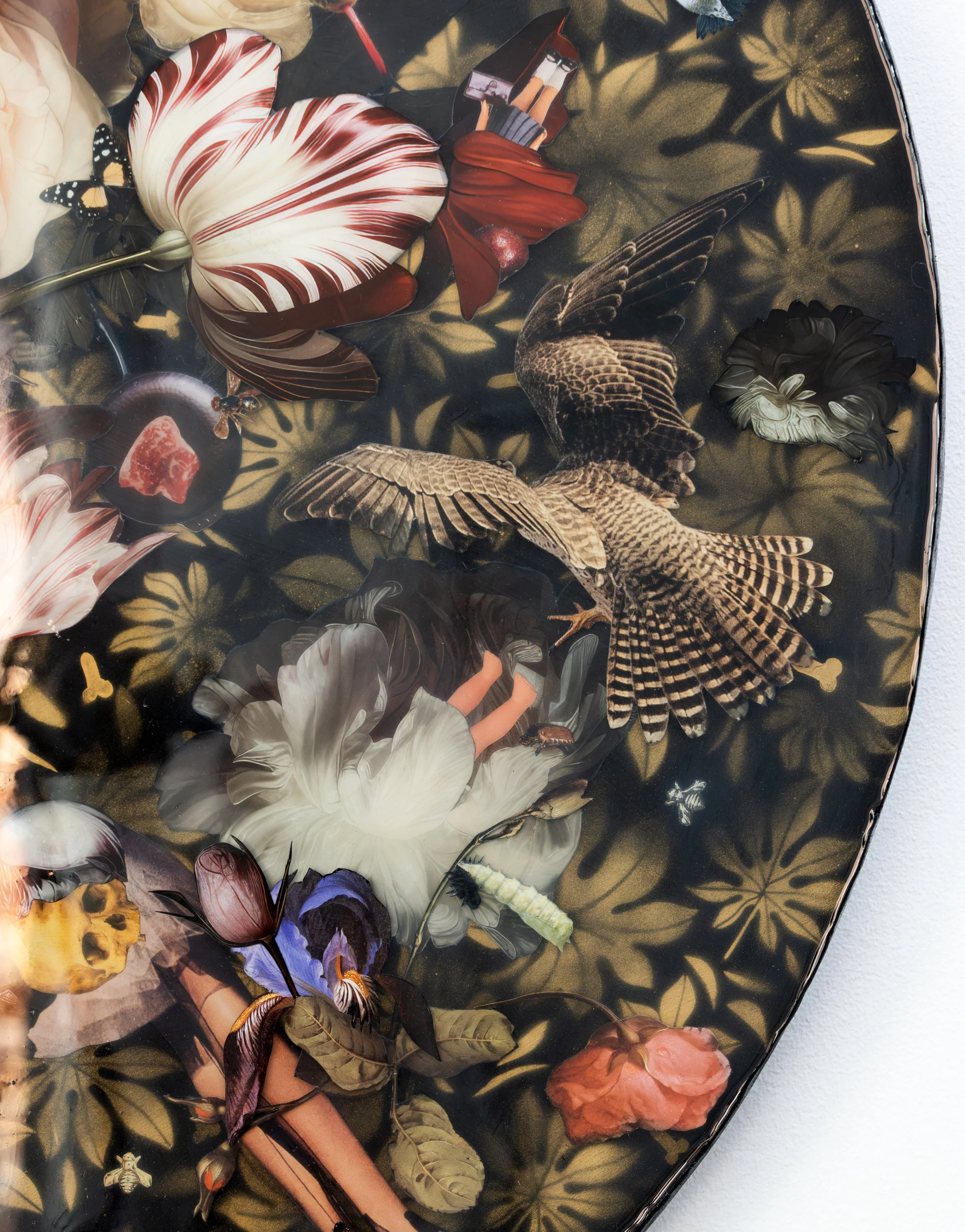 Close-up of a decorated tray with butterflies, flowers, a woman in white and purple clothing, a piece of meat, and a bee, set against a dark background with floral patterns.