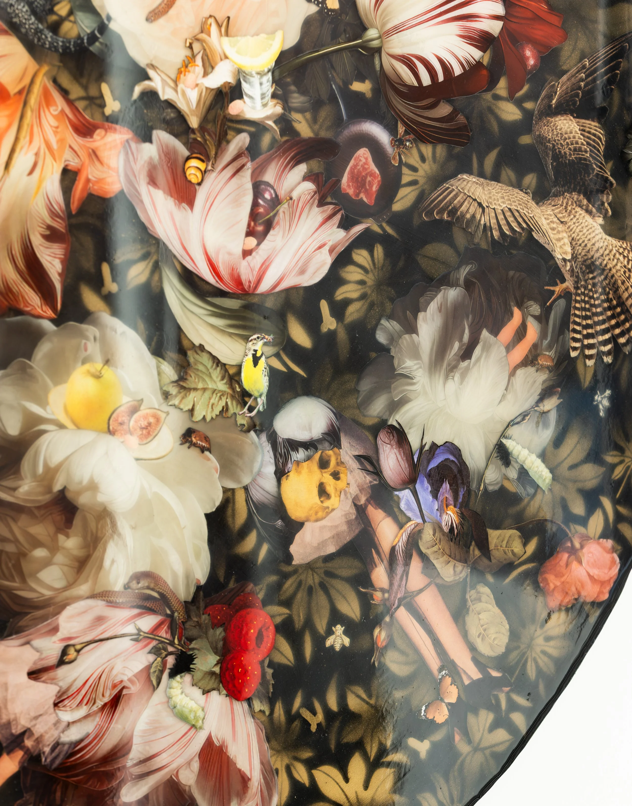 A colorful tabletop scene with artificial flowers, strawberries, a banana, a lemon wedge, a piece of steak, a honeybee, a butterfly, a small bird, and various decorative elements on a black background with golden leaf patterns.