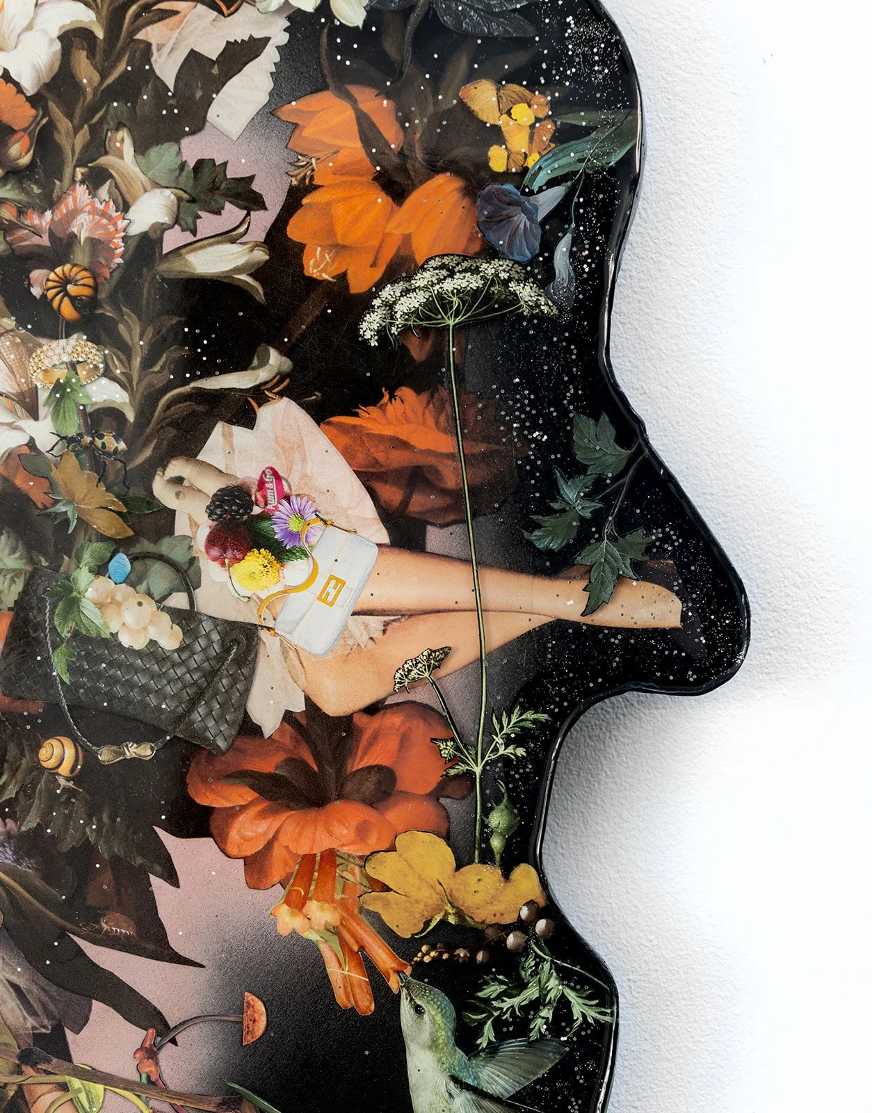A decorative glass piece featuring a collage of flowers, leaves, and a woman holding a white handbag with flowers, surrounded by pumpkins and foliage, with a cosmic black background.