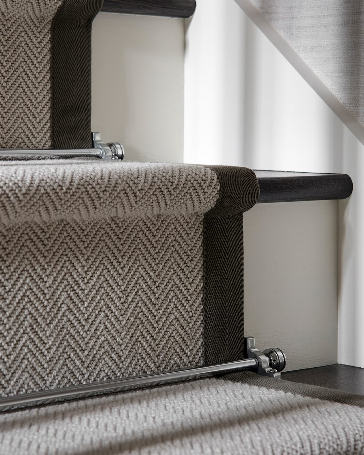 A past hallway renovation that blends timeless elegance with modern design. Originally featuring a traditional oak bifurcated staircase and cream tiled floor, the space now showcases a beautifully painted white staircase, accented with black treads a