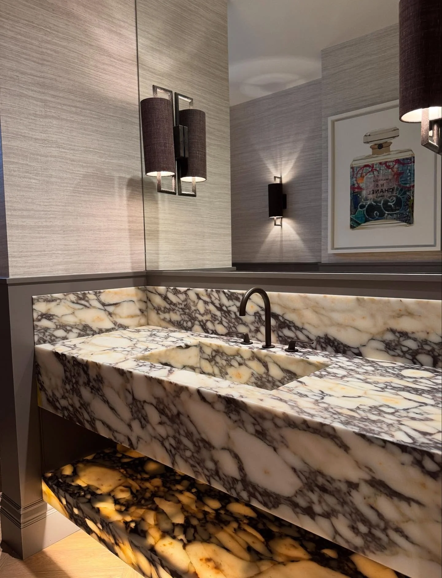 Art takes many shapes across our projects, and this breathtaking slab of Calacatta Viola marble was chosen to sculpt a truly show-stopping basin for our client&rsquo;s ground floor powder room.&nbsp;
Illuminating the bottom shelf brought the stone to