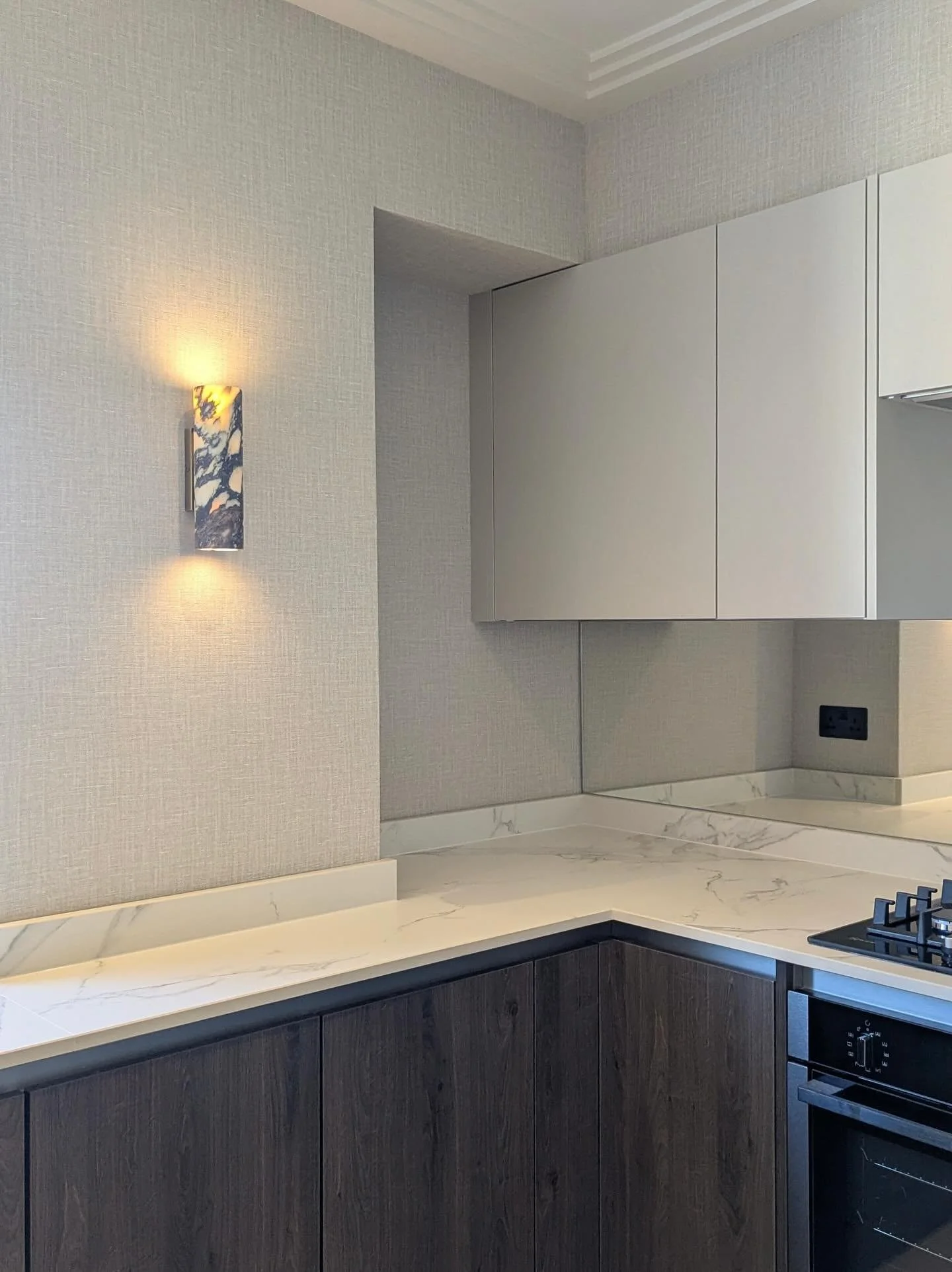 We were recently commissioned by a returning client to refurbish an apartment in Kensington for their daughter. With the budget at the forefront this project involved replacing flooring, modernising dated fittings and cabinetry, and introducing a ref