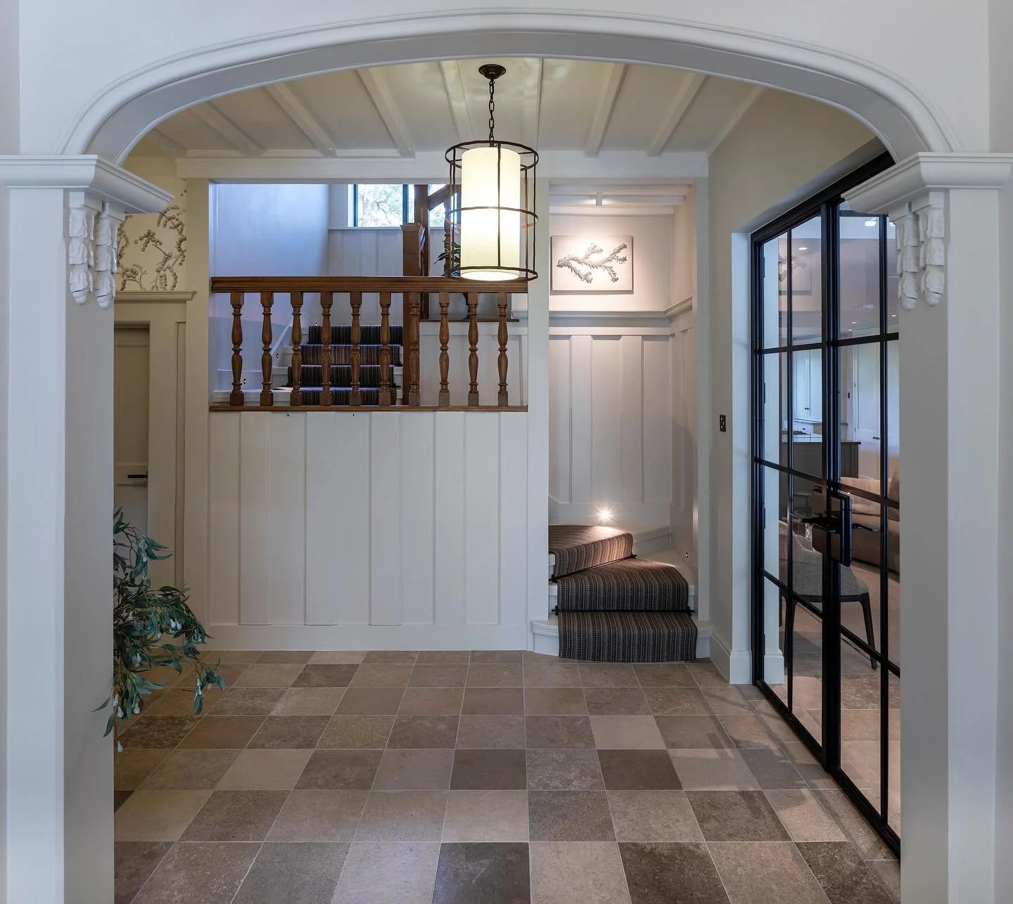 ✨ From dark and heavy to light and uplifting ✨ This once dark timber panelled arts &amp; crafts hallway with an oak floor has been completely transformed. We introduced a checkerboard limestone floor for timeless character and painted the original pa