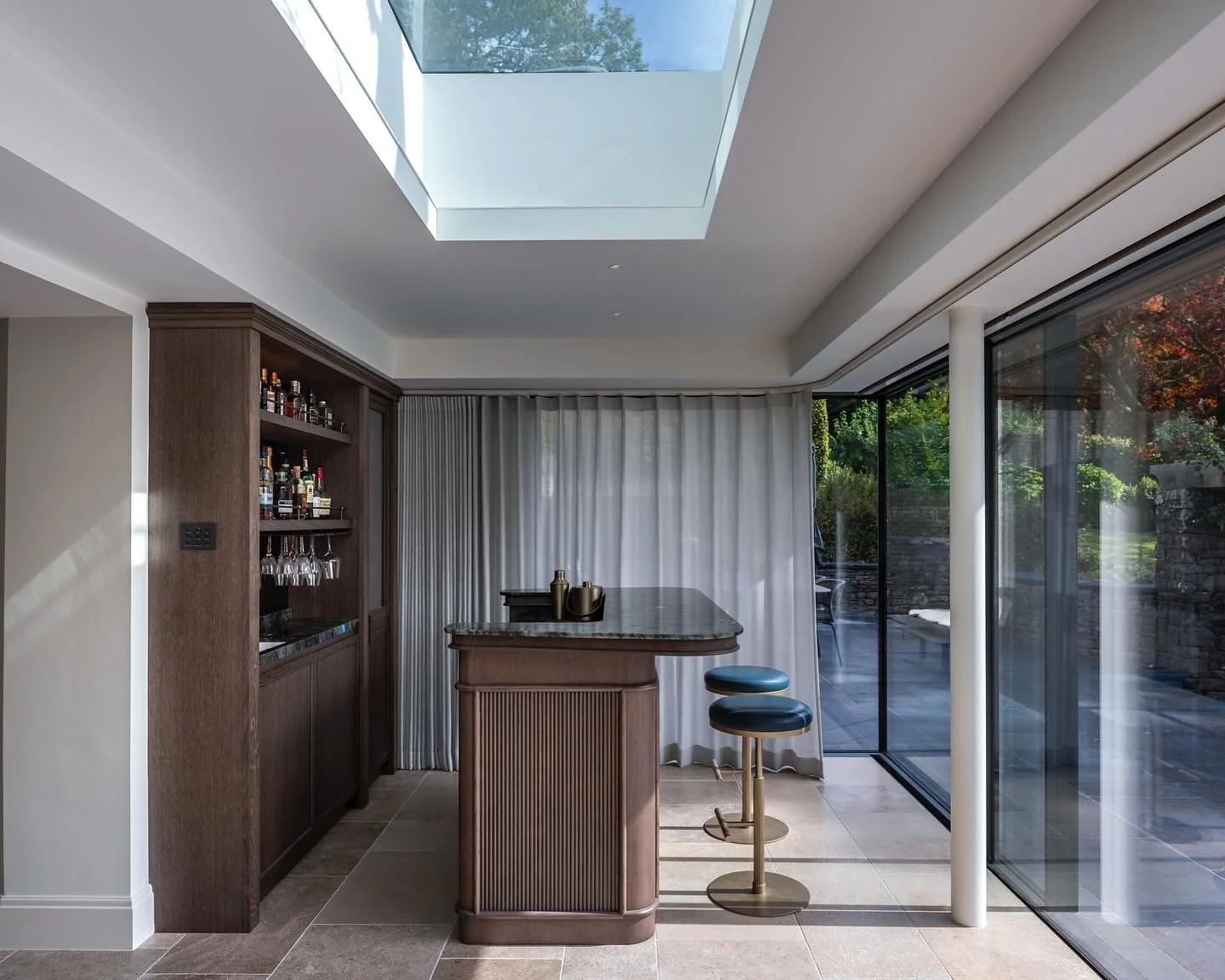 ✨A serene retreat in the Lake District ✨
This garden room was designed as a tranquil extension of the home — a space to unwind, entertain, and take in the surrounding landscape.
A bespoke bar anchors the room, crafted in rich timber and topped