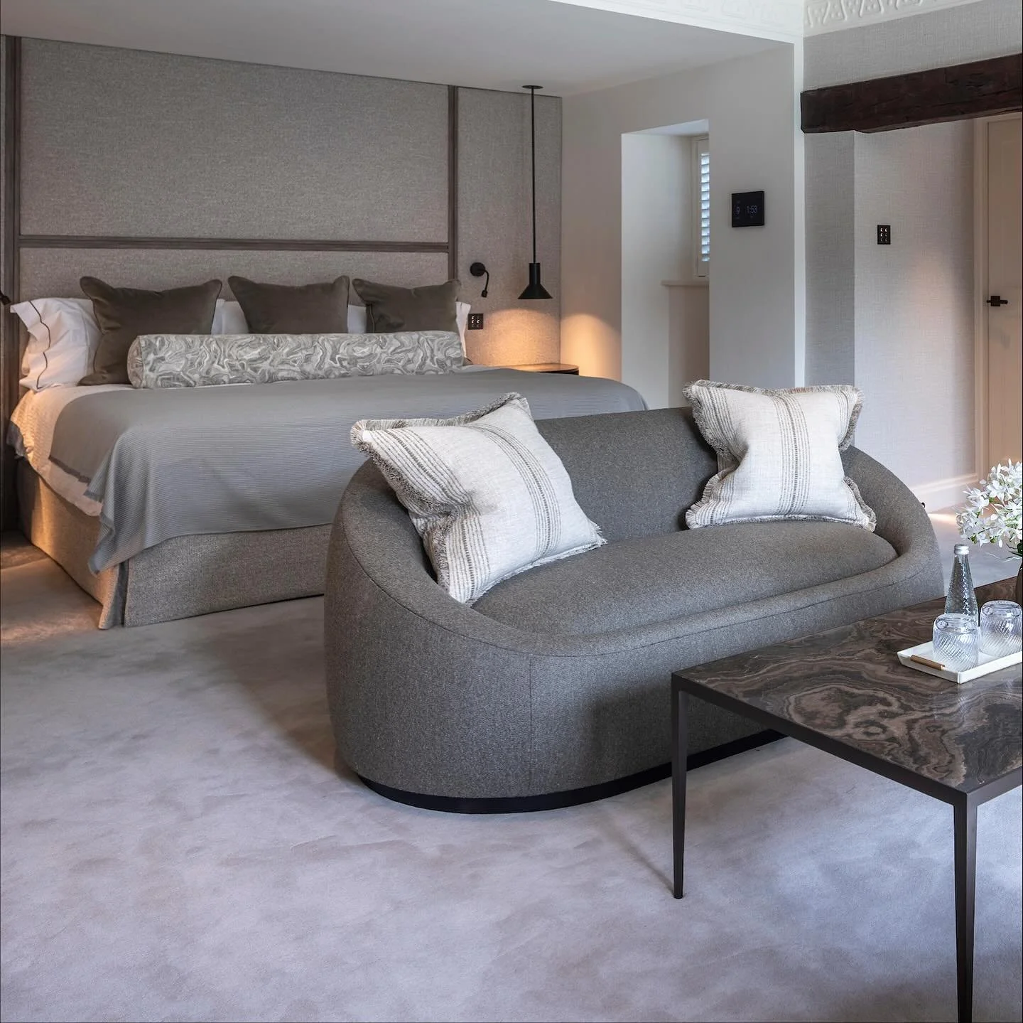 ✨A luxurious bedroom suite with a harmony of soft textures, featuring a full-height upholstered headboard with timber detailing and a cosy sitting area centred around a marble fireplace &mdash; the ultimate place to relax and unwind.
Beyond the bedro