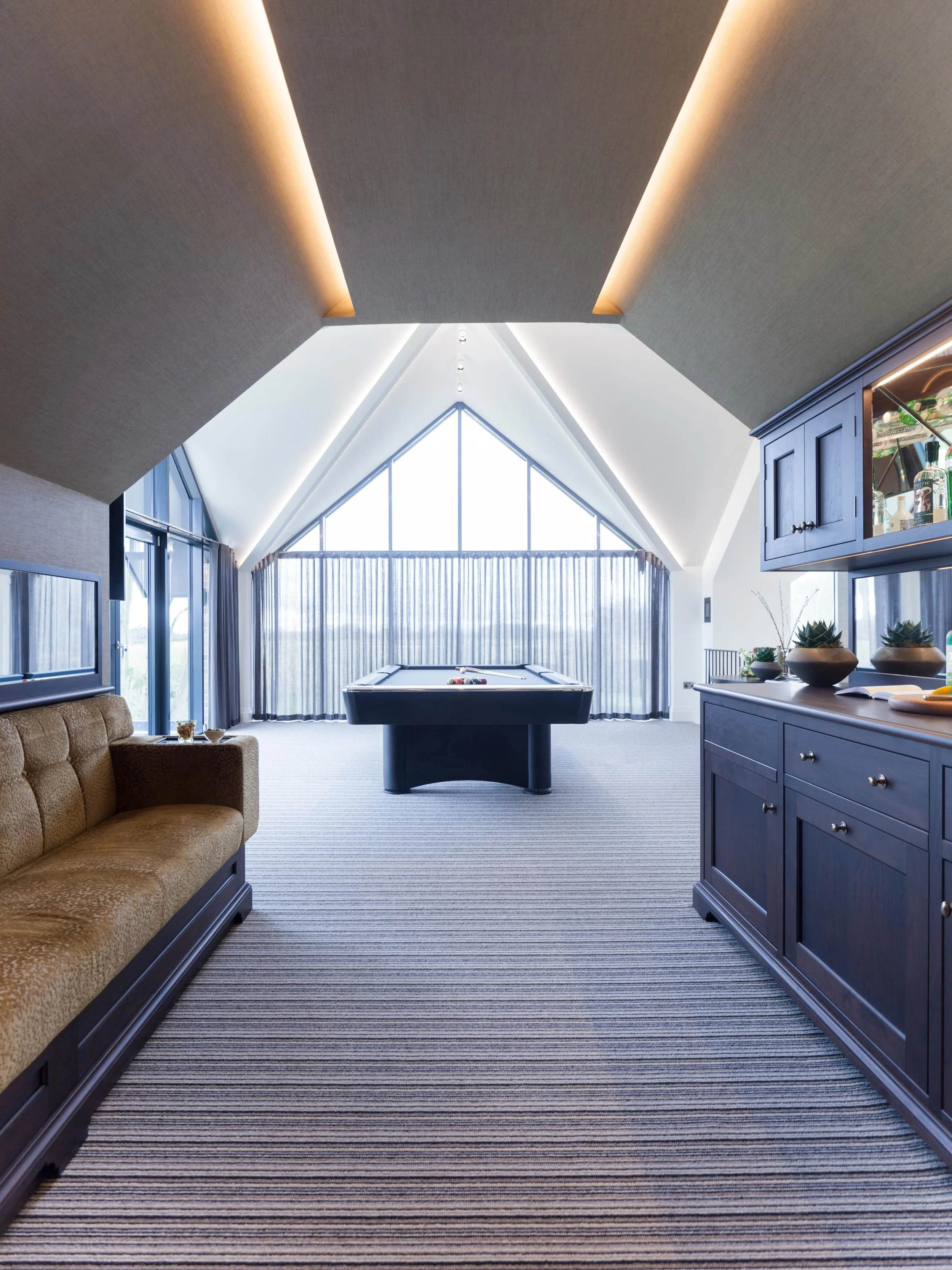 A decade on, and this entertaining space still feels as special as the day it was completed.
Designed as a dedicated extension for our clients to relax, host and unwind, this vaulted games room was created to feel both dramatic and inviting. 
From th