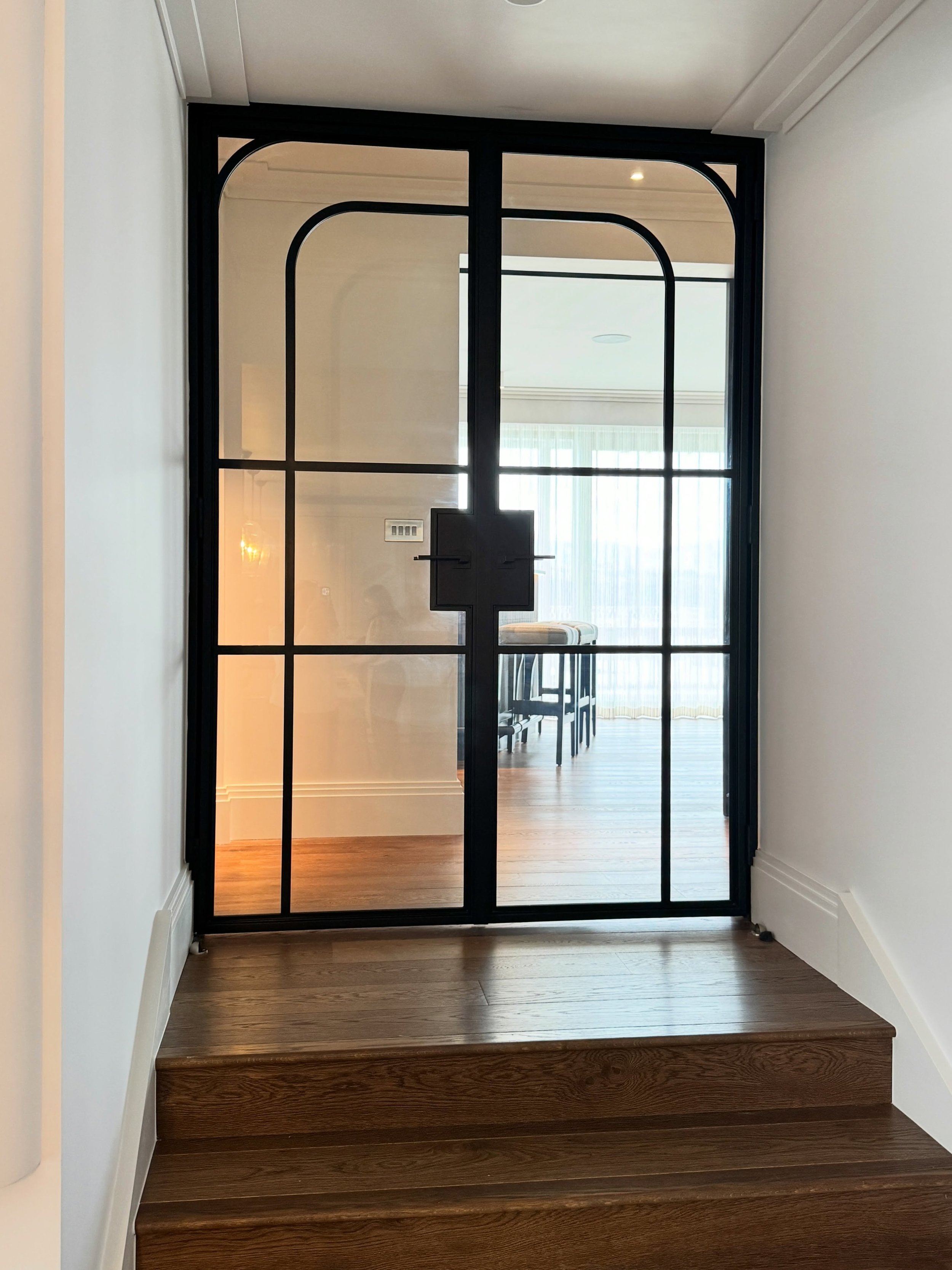 For these bespoke Crittall-style doors, we explored two different designs with our clients, drawing each option so they could clearly visualise how the finished doors would sit within the space.  We were drawn to the softer architectural detailing of