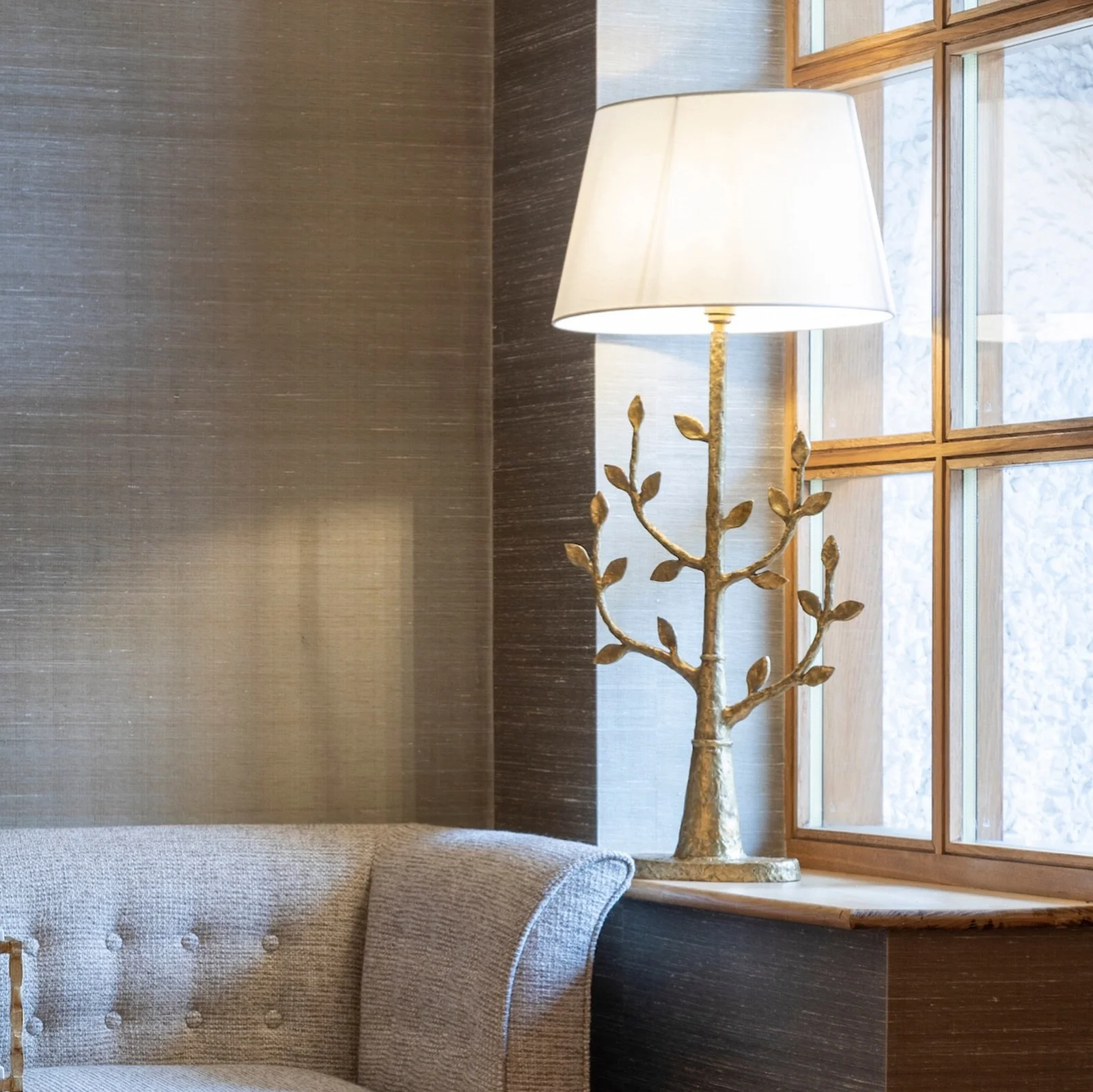 Visible from outside, this beautiful and sculptural &lsquo;Tree of Light&rsquo; lamp casts a warm glow through the hall window, gently guiding you in.  Its branching form brings a touch of nature to this welcoming corner.
Inside, the same inspiration