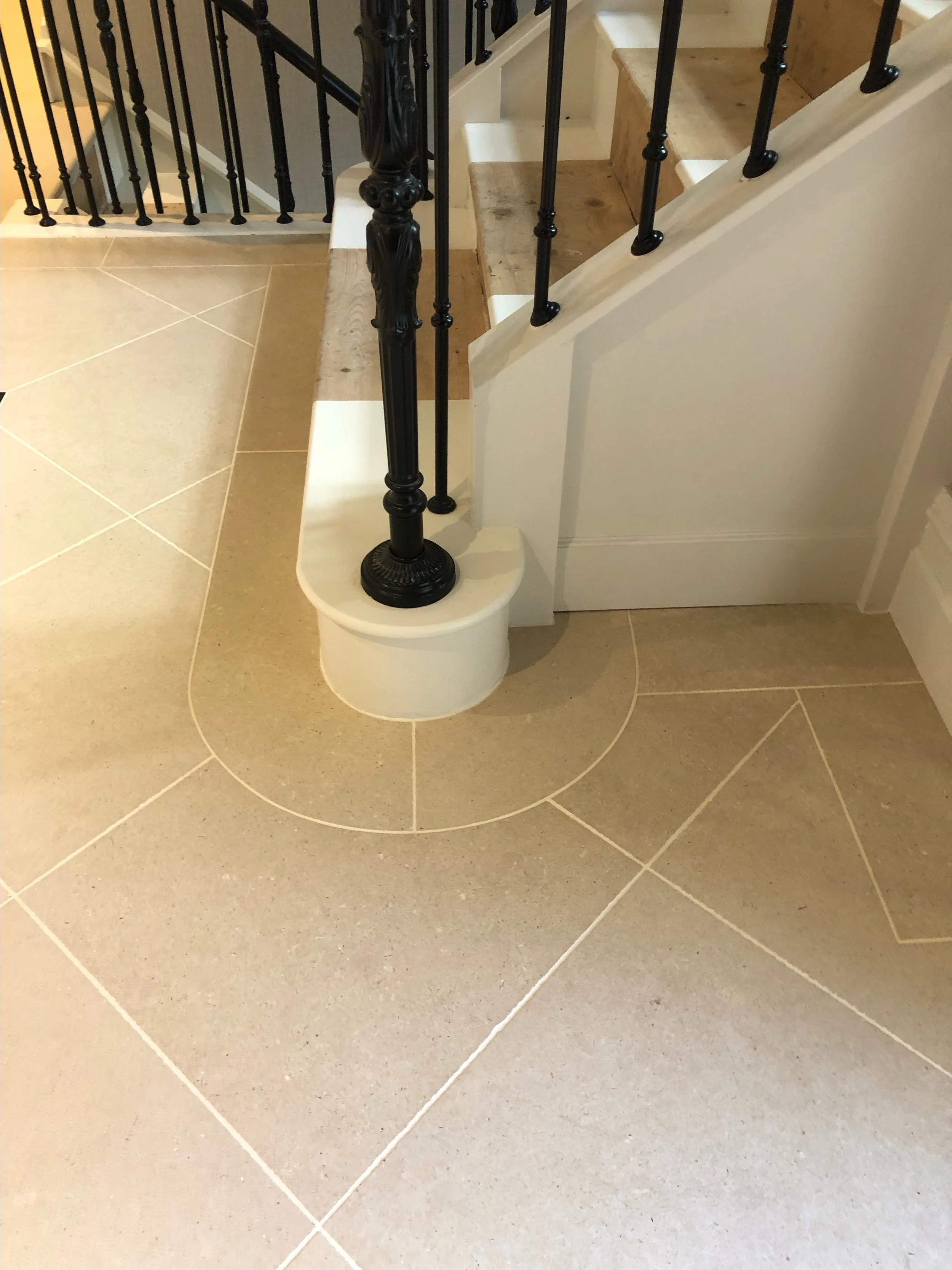 The beautiful curved stone detailing around the base of this staircase is a lovely example of how thoughtful design and skilled craftsmanship come together.

Carefully considered stone cuts and precise installation allow the flooring to flow seamless