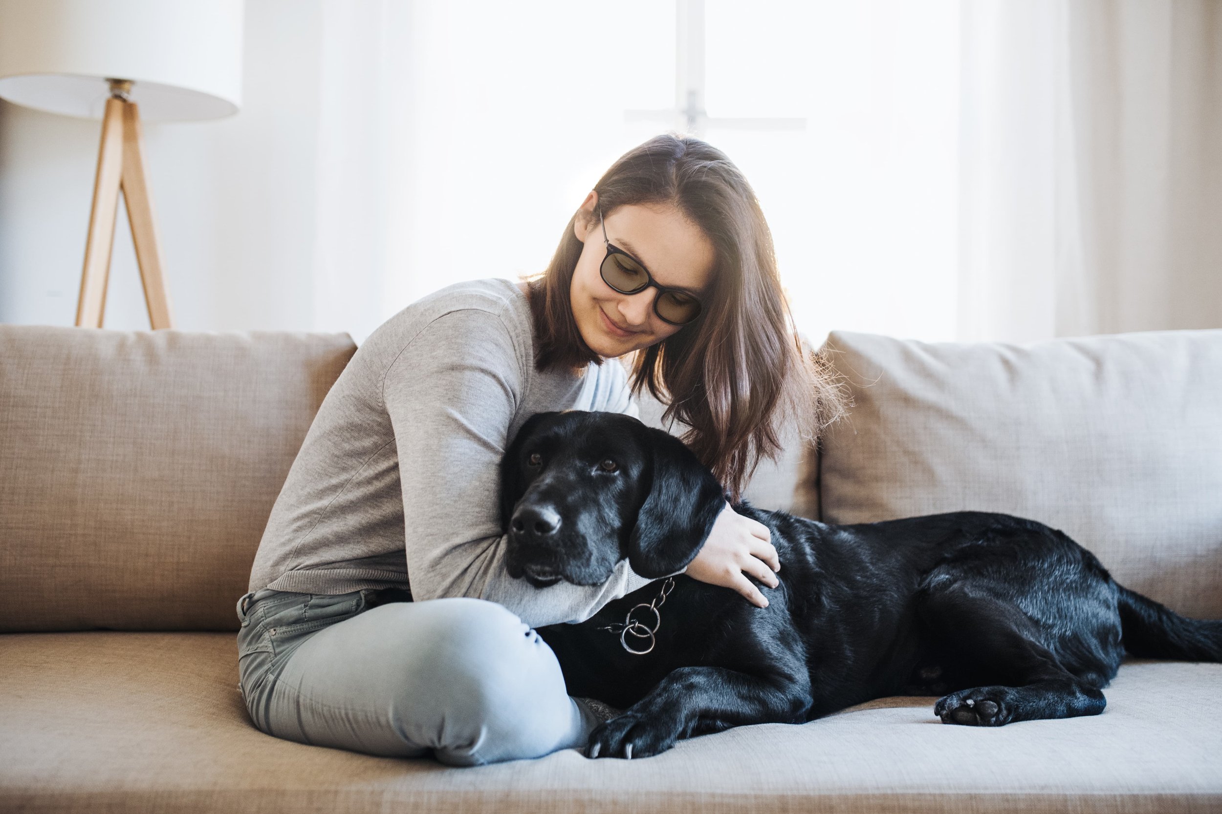 woman wearing migraine and light sensitivity lenses at home